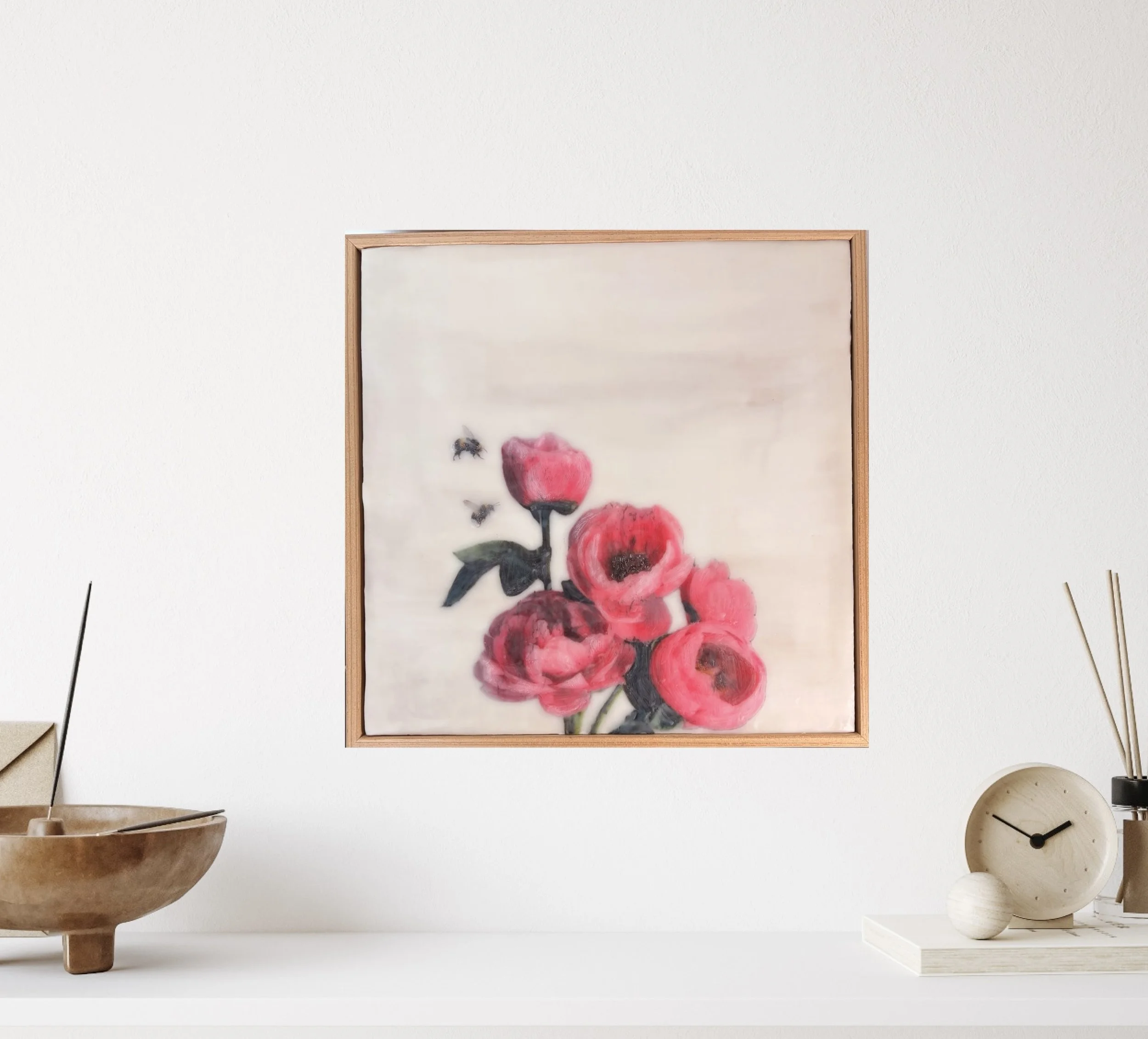 an encaustic wax/mixed media artwork of soft pink flowers and two bees