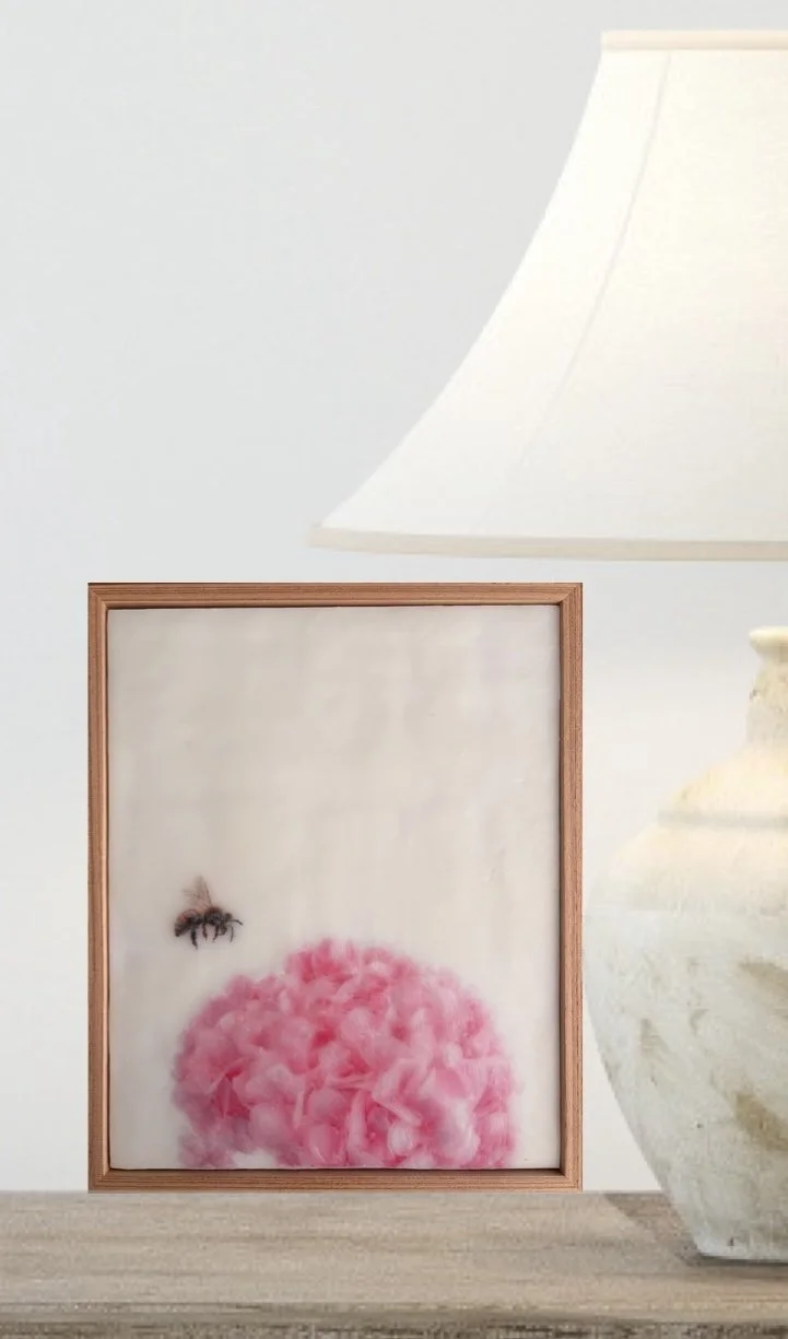 Original encaustic wax artwork of a honeybee hovering beside soft pink hydrangea flowers, framed in Tasmanian oak with a dreamy, luminous botanical finish.