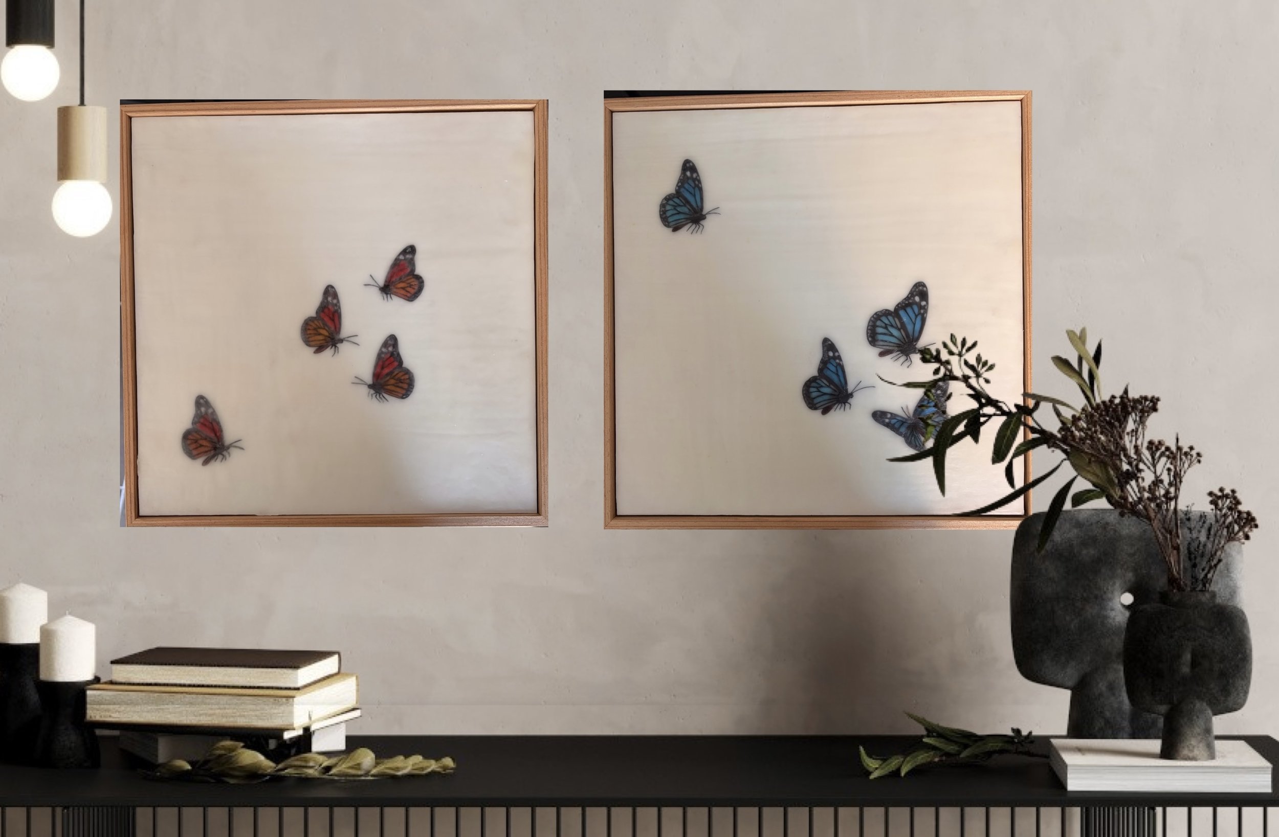 Minimalist encaustic wax artwork featuring four blue butterflies floating across a luminous ivory background within a natural timber frame. Contemporary, serene wall art by Karen Canning.