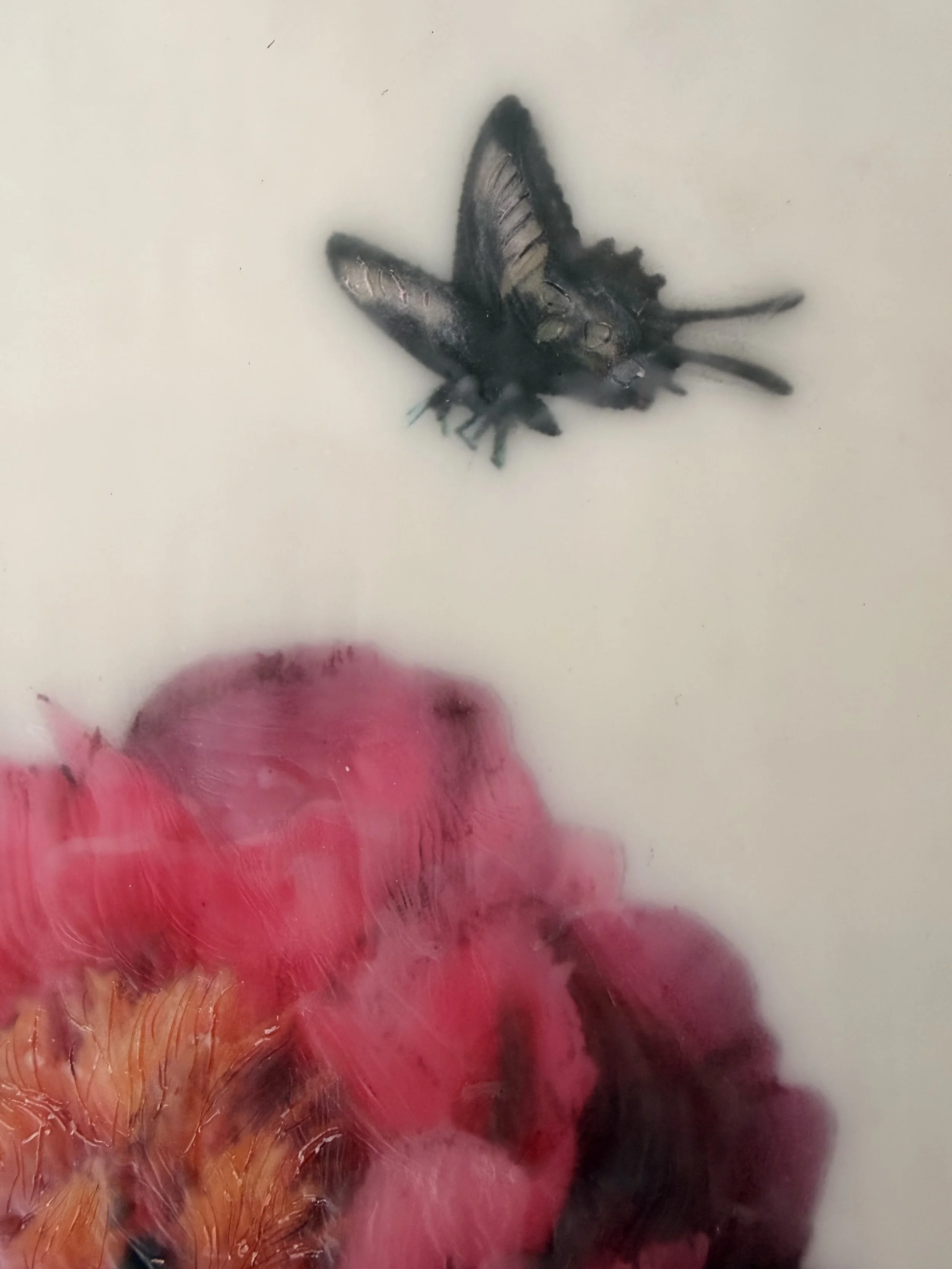 Encaustic wax artwork of a soft pink flower with a delicate butterfly hovering above, created with layered wax textures and gentle blended tones.