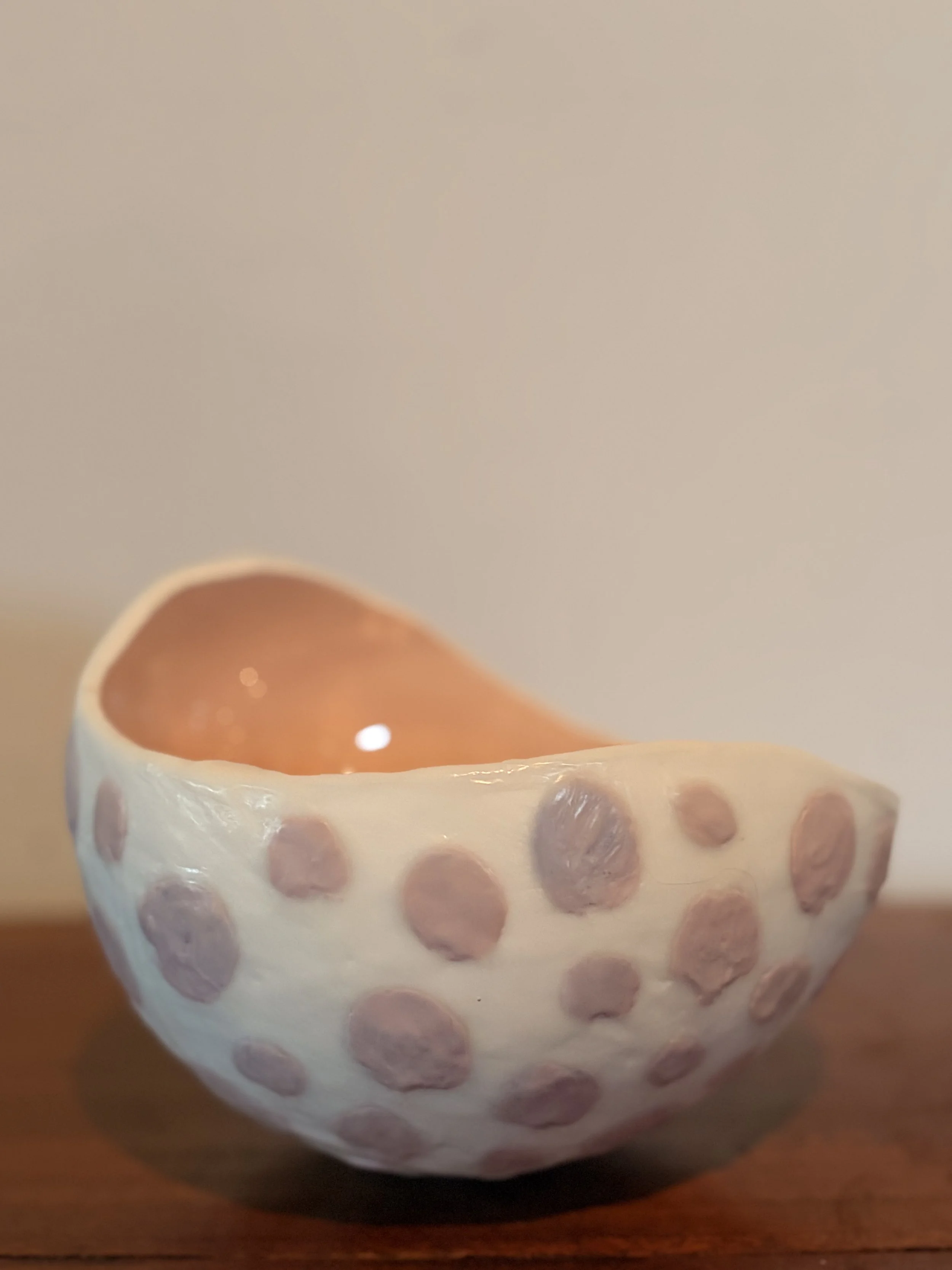 Original encaustic wax and resin vessel titled Musk Stick by Australian artist Karen Canning featuring soft blush pink raised dots on an ivory beeswax surface with a glossy pale pink resin interior.