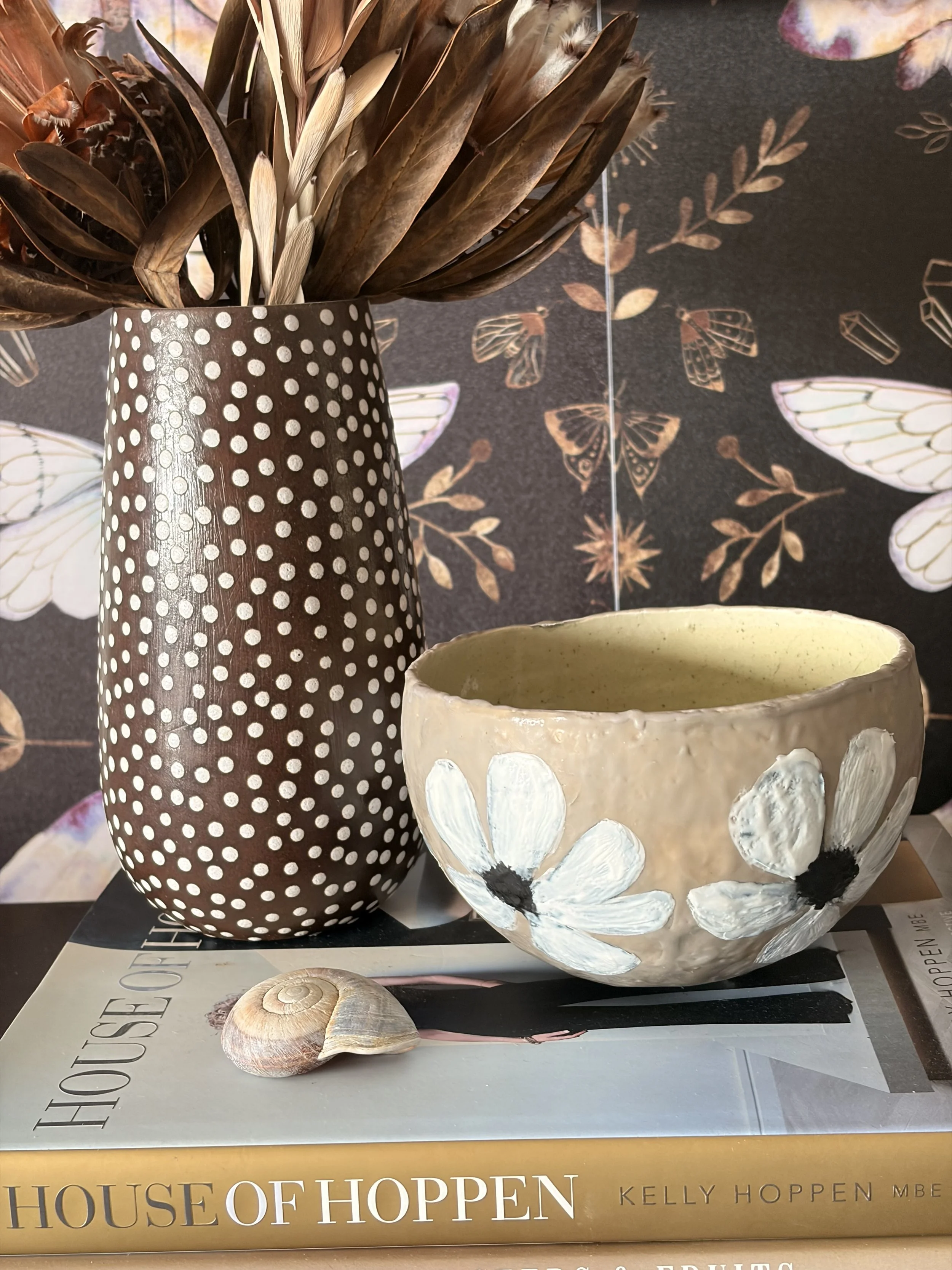 Small encaustic wax artwork titled “Hello Daisy”  featuring a delicate daisy motif, layered beeswax texture, and a soft glossy resin finish, handmade by Australian artist Karen Canning.