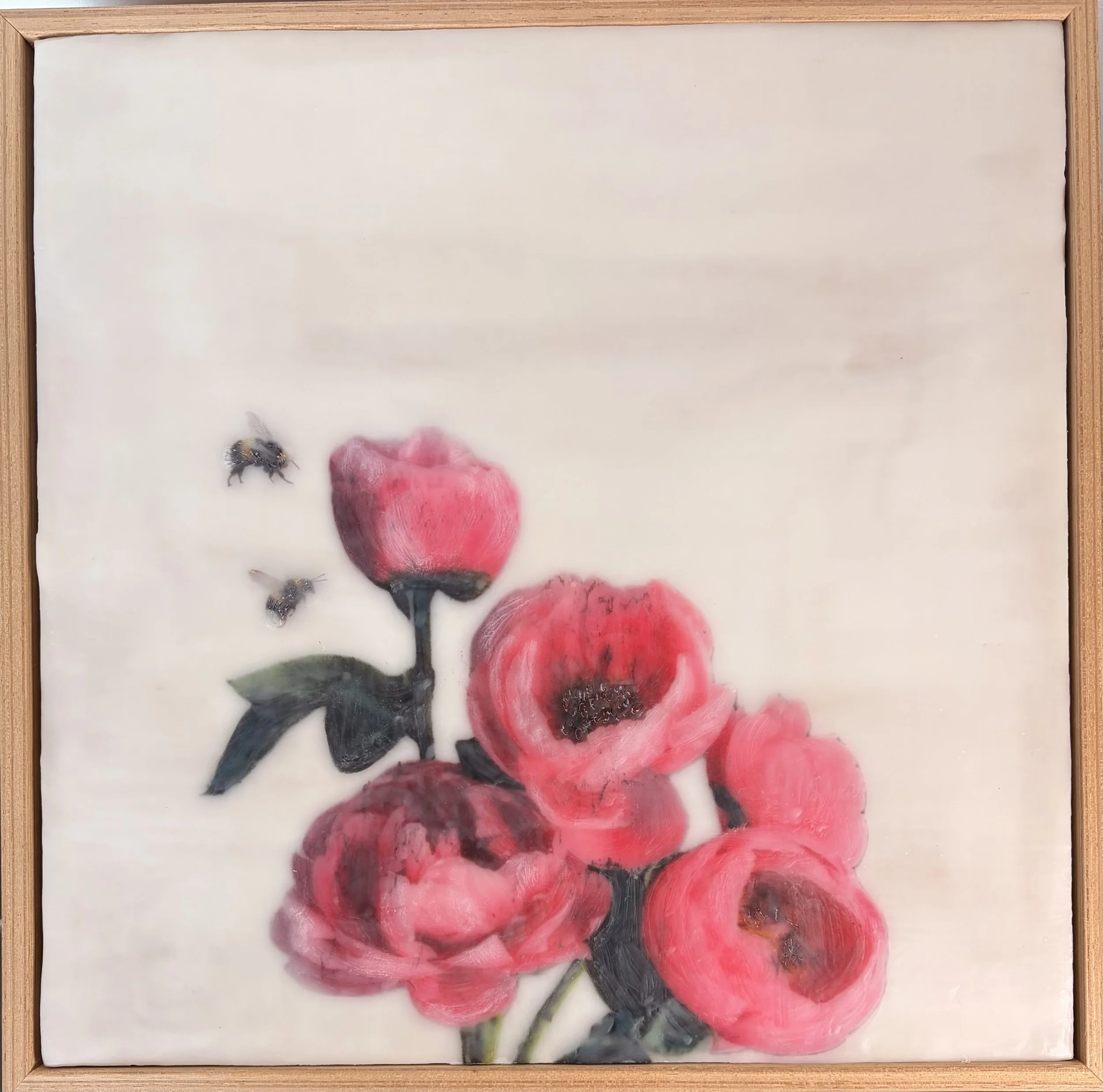 an encaustic wax/mixed media artwork of soft pink flowers and two bees