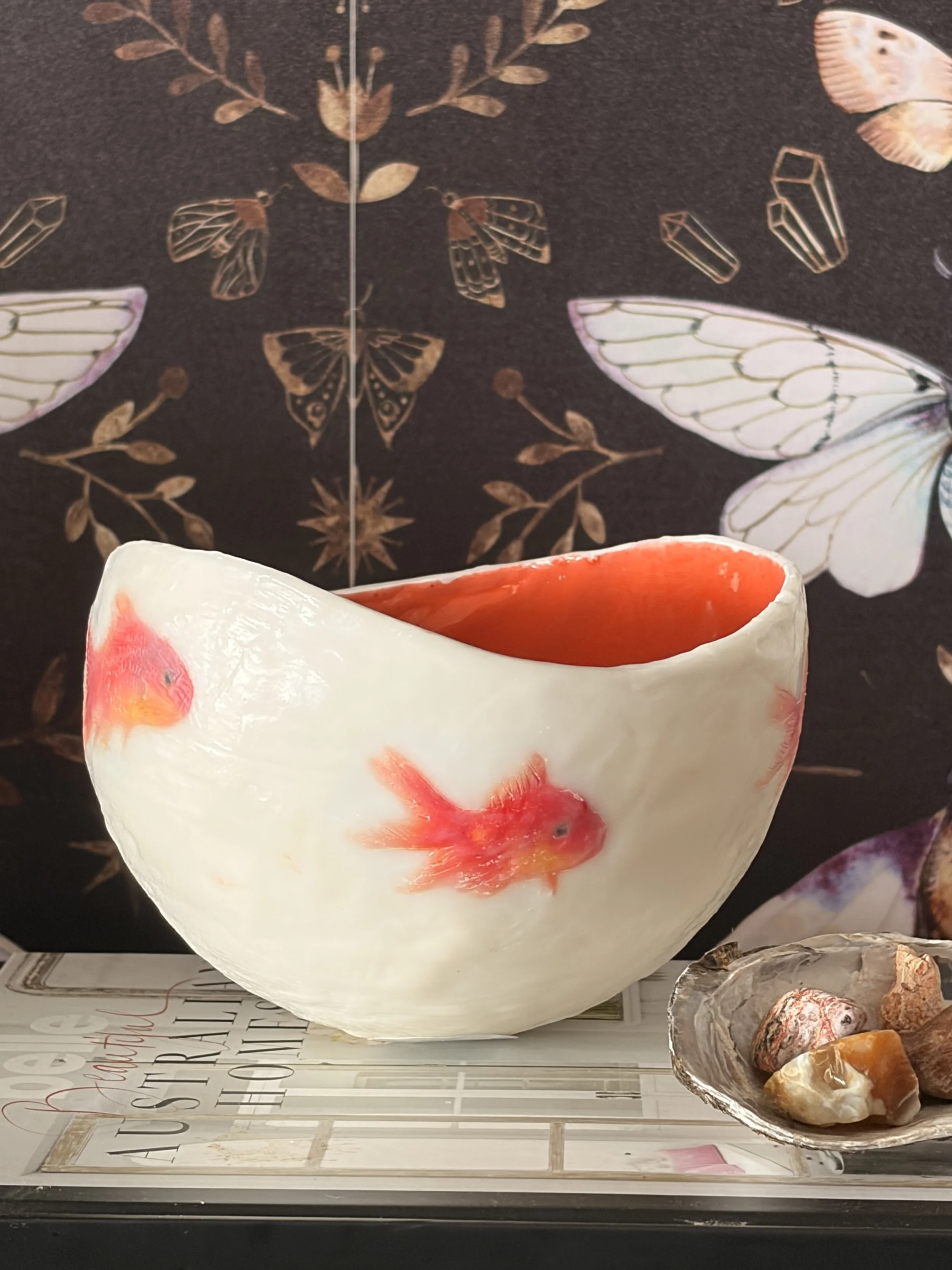 Handmade encaustic wax vessel with luminous  white exterior and goldfish design, featuring soft translucent layers and a warm orange interior, 17 x 13 cm sculptural art bowl.