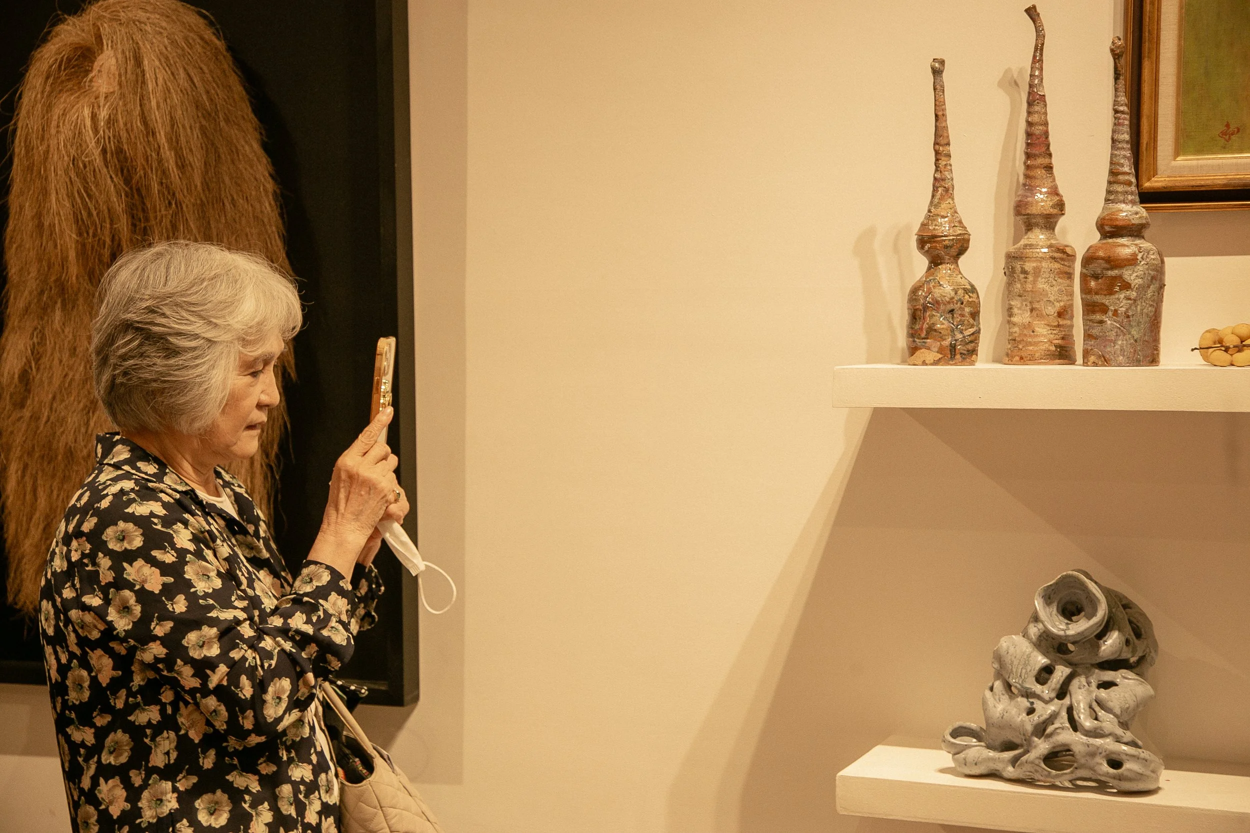 Kikufuji Izakaya owner Ritsuko Kikuchi at Perfecto Deli, taking photos of ceramics by Jose Solon Perfecto