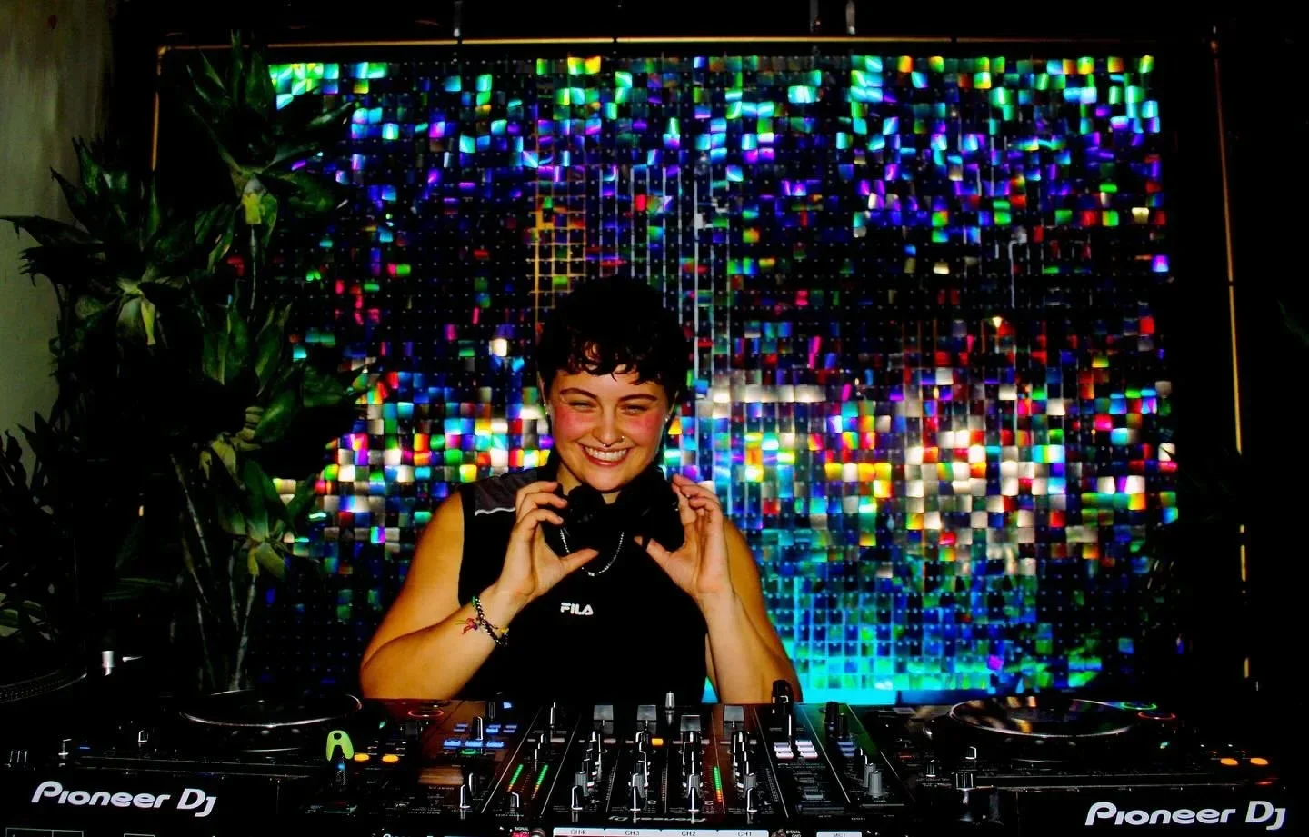DJ smiling behind the booth at Oculist Brighton.