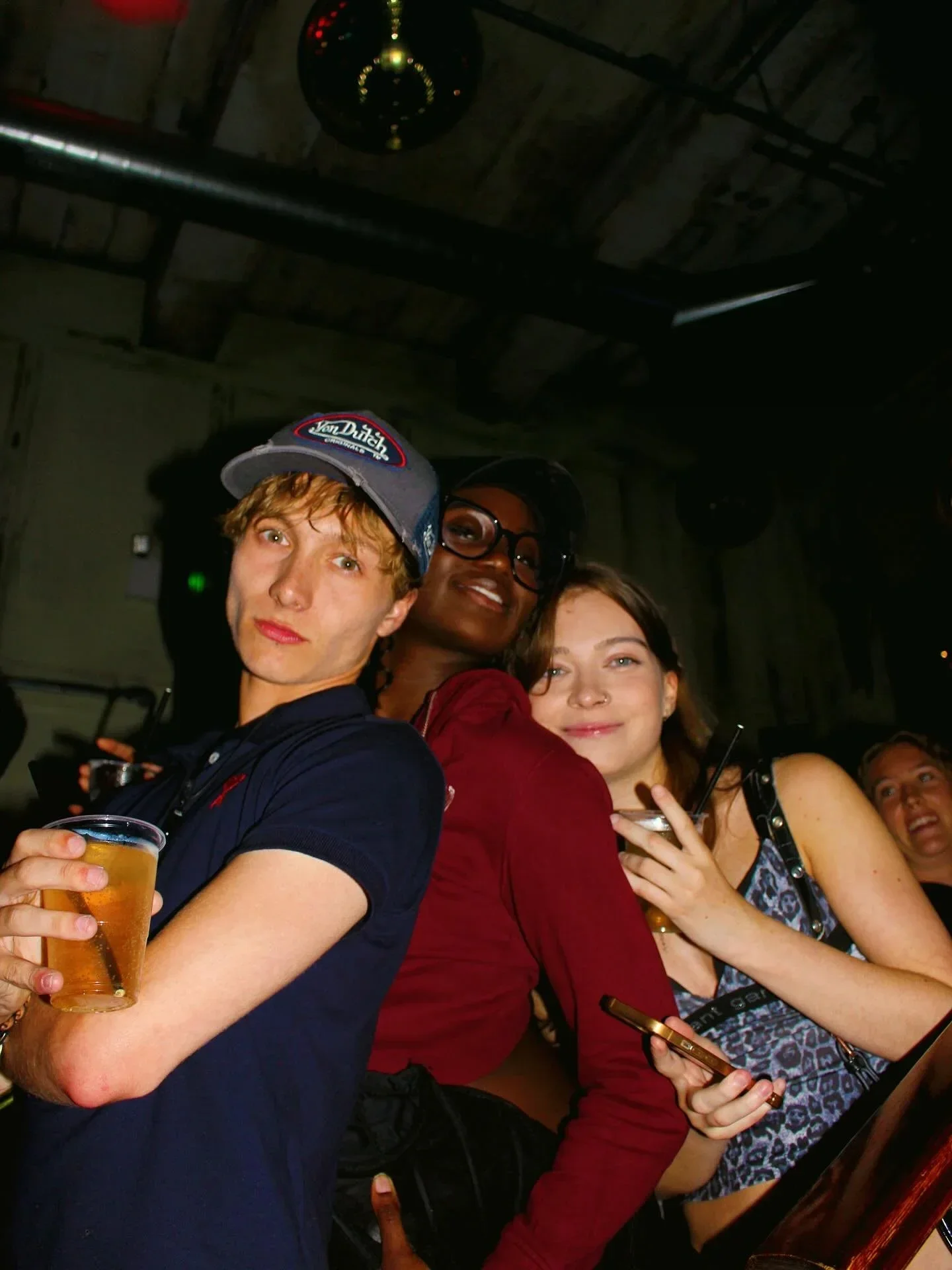 Group of students holding drinks during a night out at Oculist Brighton.