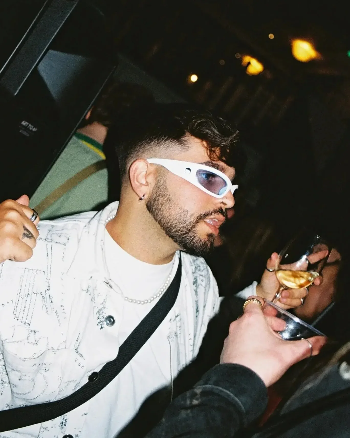 Guest holding a drink during a student night at Oculist Brighton.