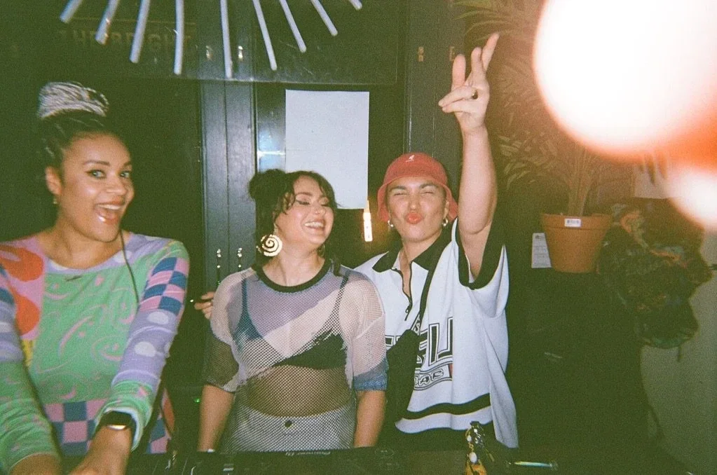 DJs and guests smiling at a party inside Oculist Brighton.