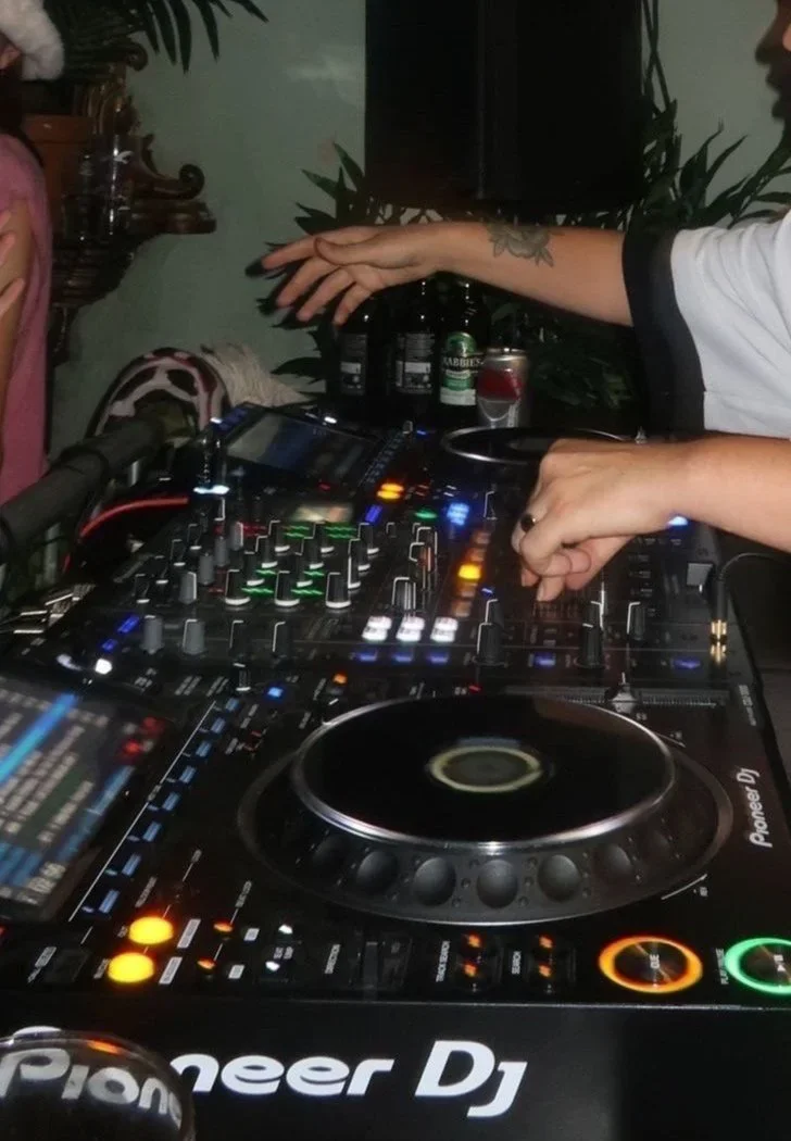 DJ mixing on Pioneer decks at an Oculist Brighton event