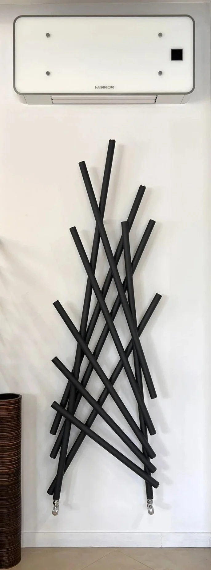 Tsolakidis store display featuring decorative heating radiator and fan coil unit.