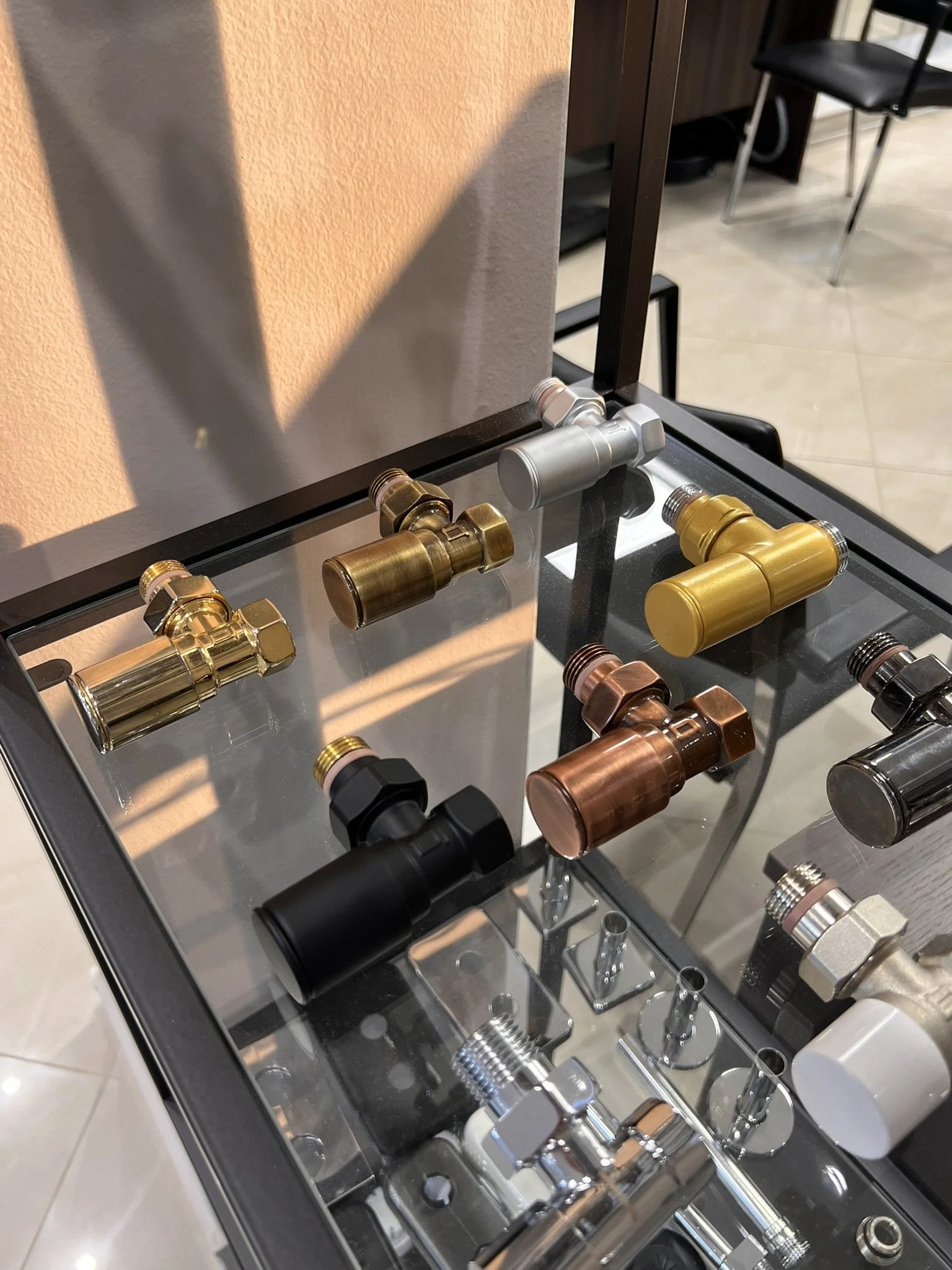 Tsolakidis store display with a variety of radiator valves in different colors