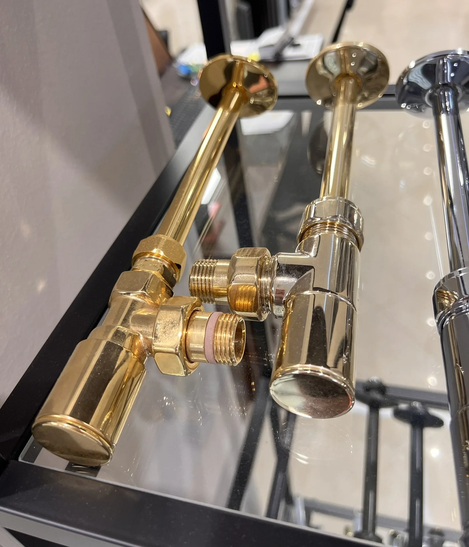 Tsolakidis store display with a variety of radiator valves in different colors