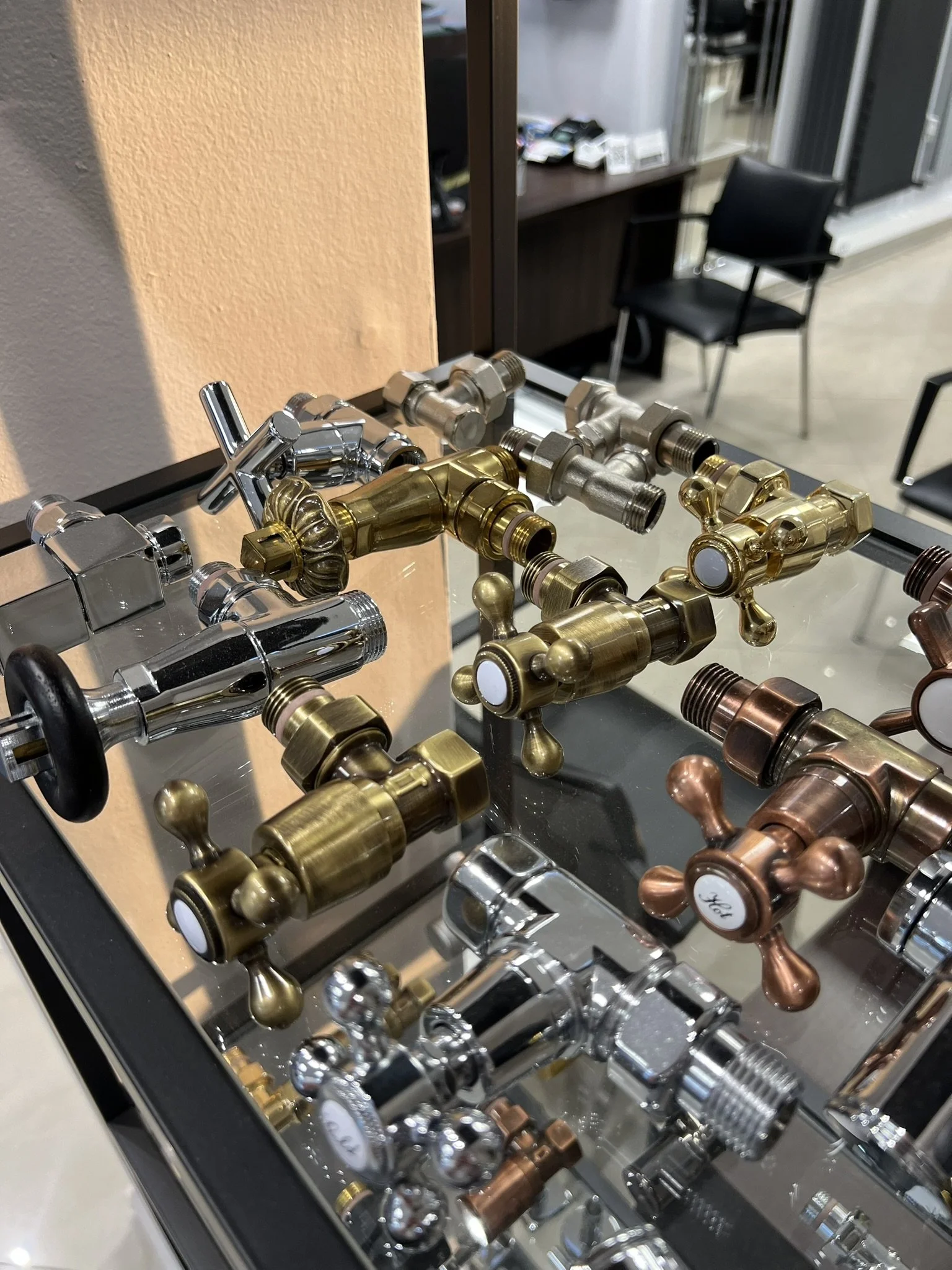 Tsolakidis store display with a variety of radiator valves in different colors