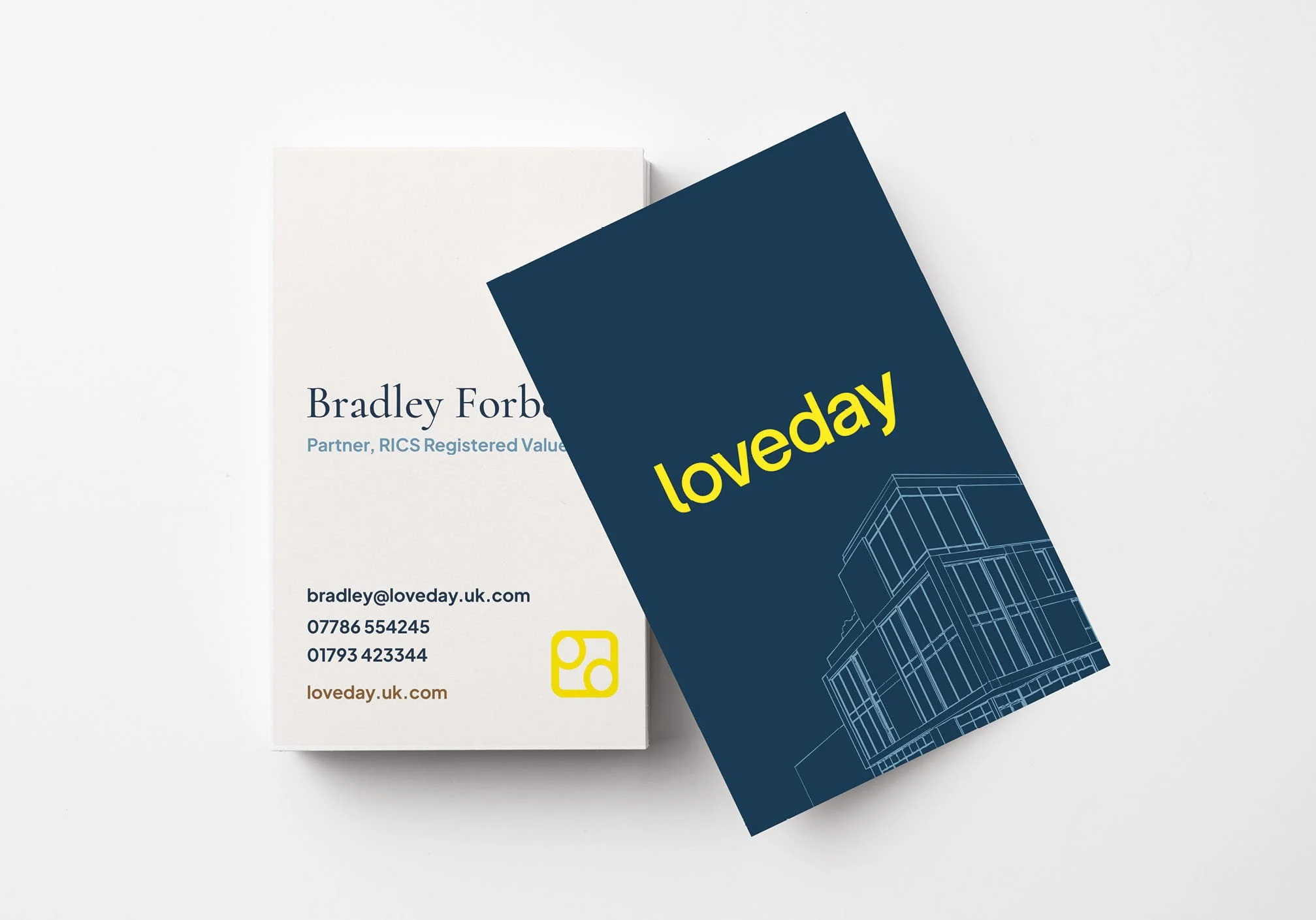 Business cards for Bradley Forbes, featuring contact information and a graphic of a modern building, with the slogan "loveday" in yellow on a dark blue card. Design by Hubble - real estate marketing material.