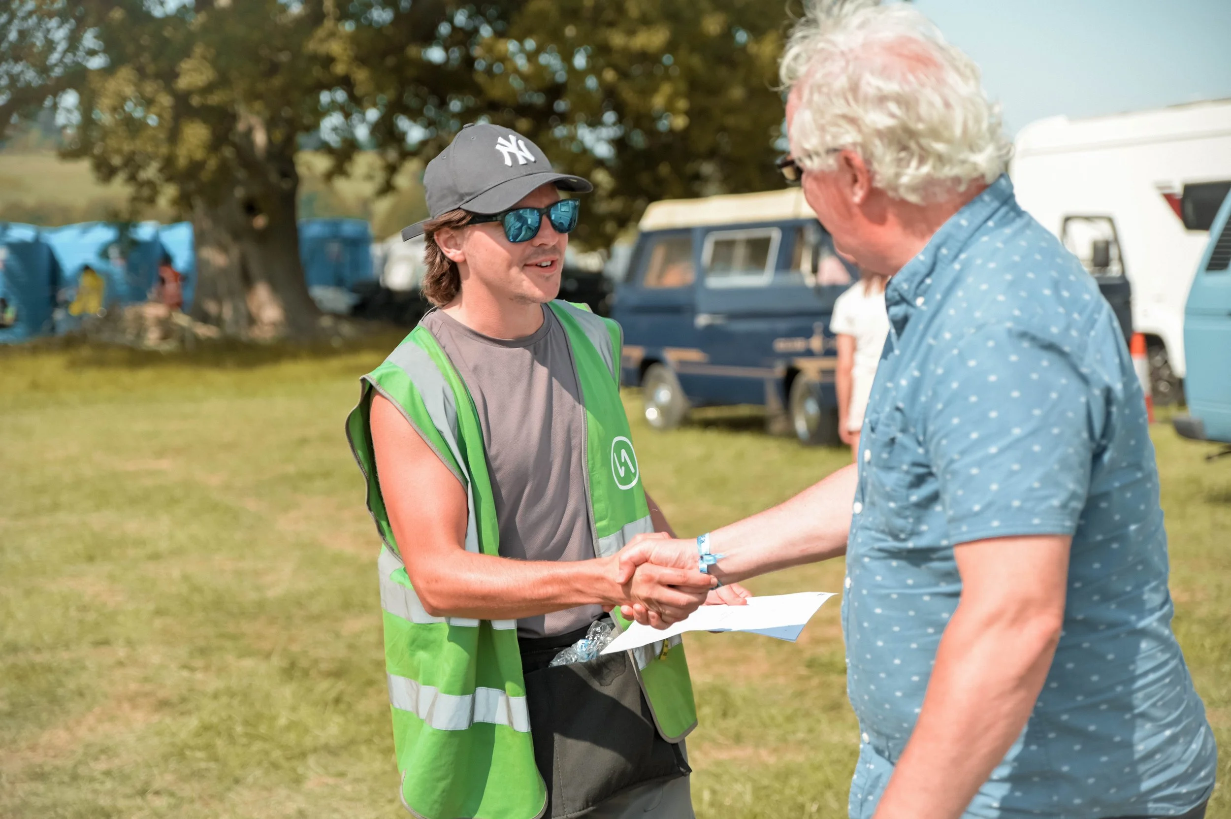A FestivAll Staff team member shaking the hand of a satisfied customer