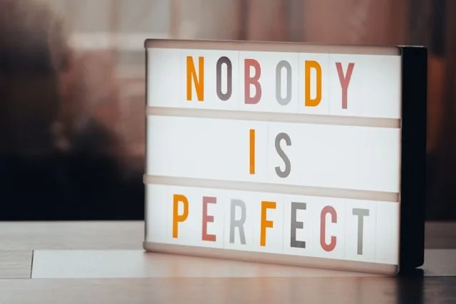 Sign that says "Nobody is Perfect"