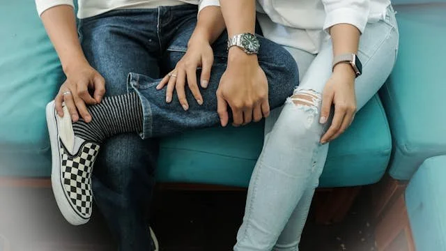 young couple sitting next to each other