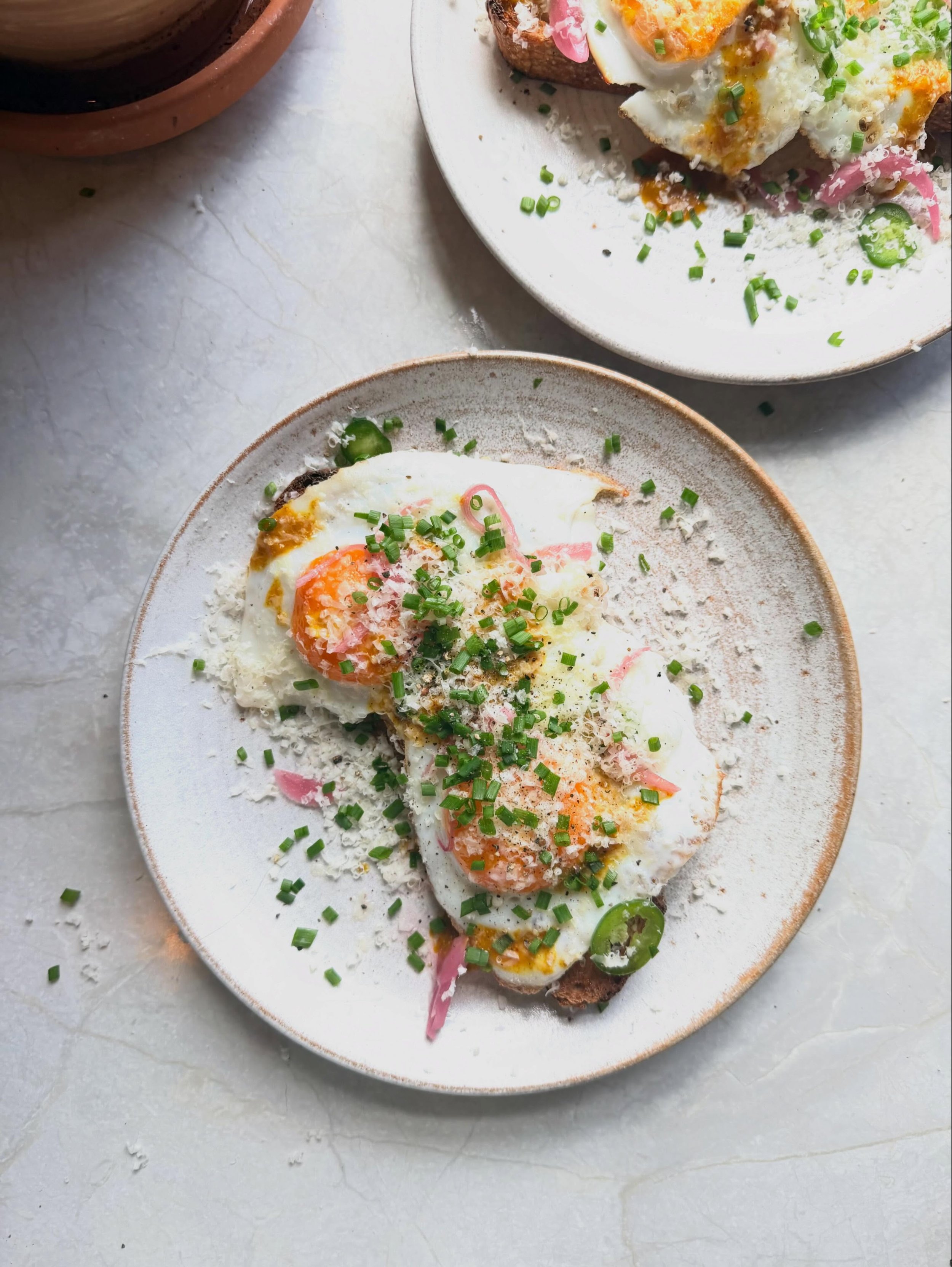 Current favourite eggs at the moment&hellip; spicy &amp; salty and featuring pickles because they make everything better! 

Sourdough toast, fried eggs, fresh green chilli, pickled pink onions, a drizzle of amba sauce, a good grating of the strongest