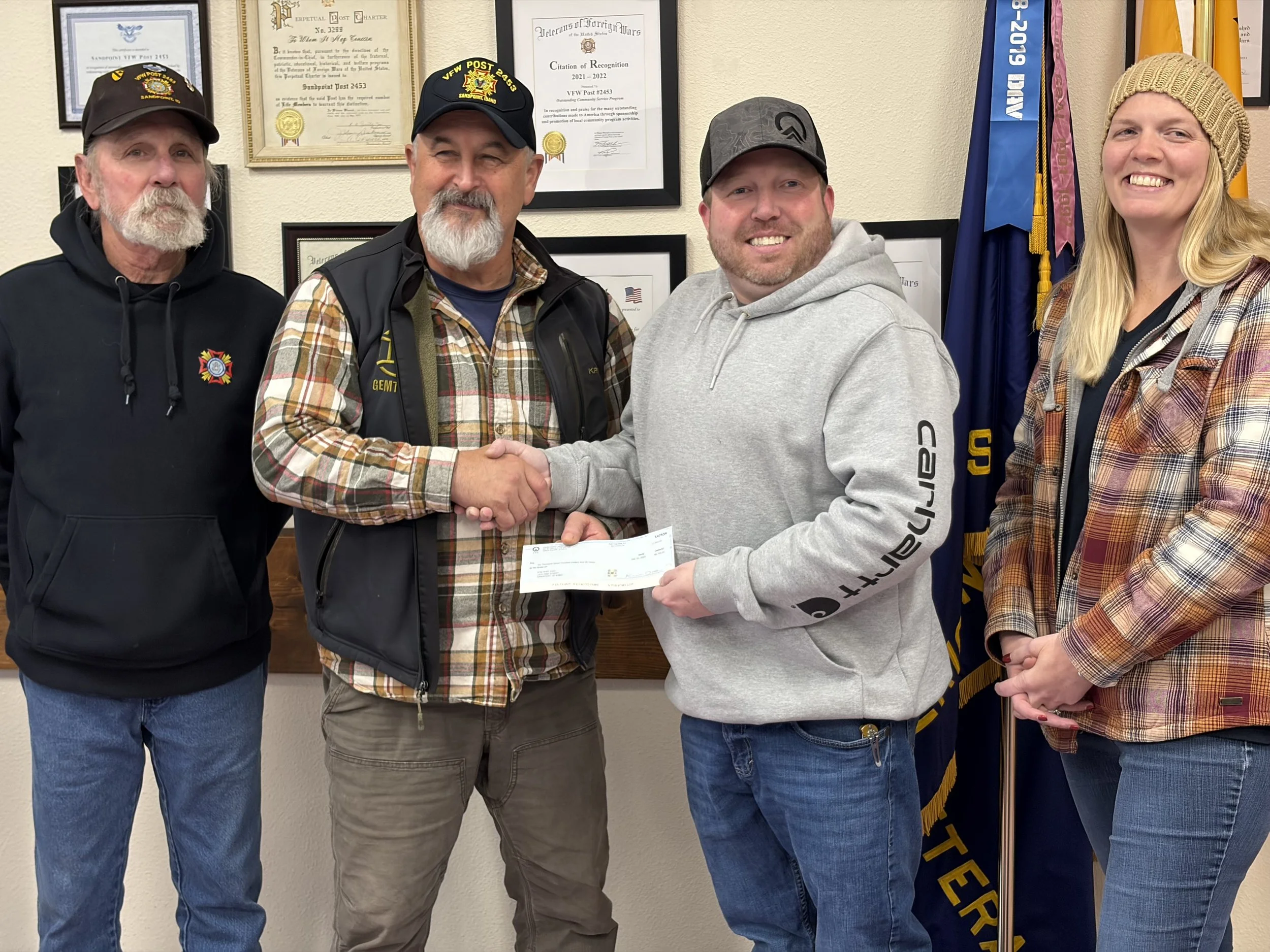 Commander Ken Hunt and Deputy Commander AJ Cruce receiving a donation check from the Idaho Forest Group (IFG) and employees of Laclede.