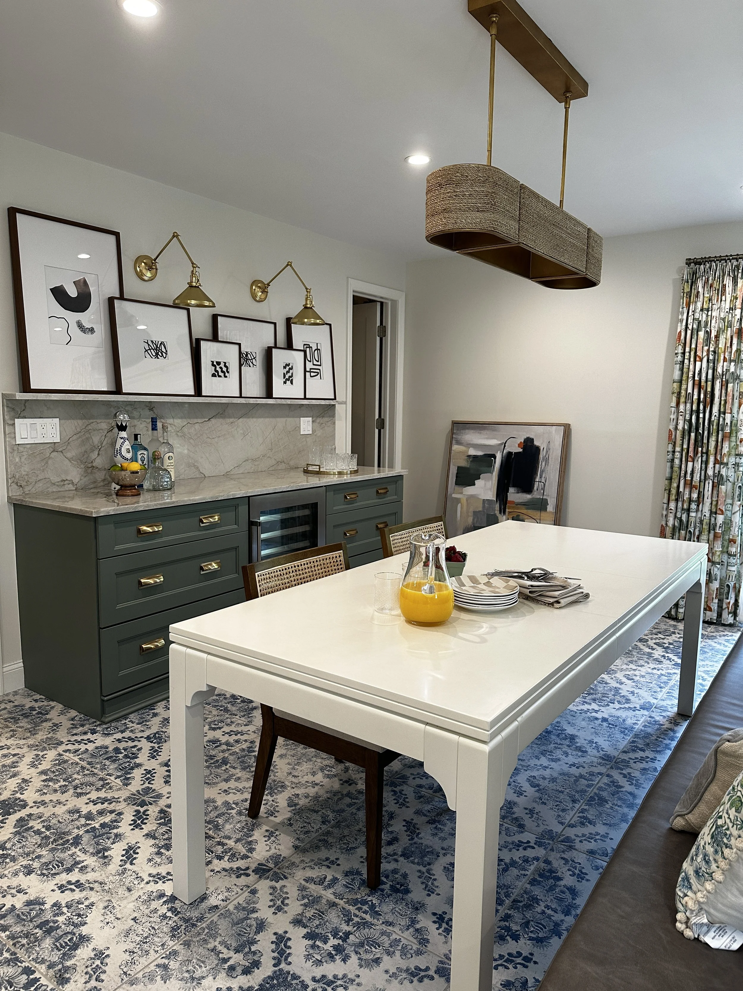 Dining area featuring a white table over blue patterned tile.