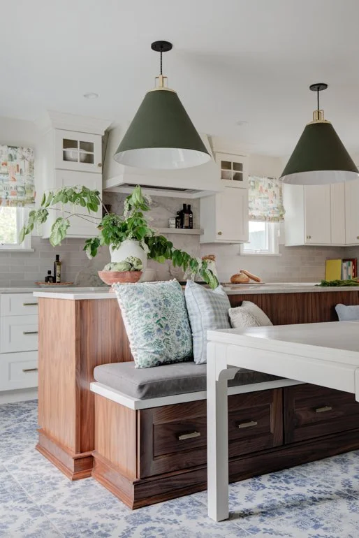 Kitchen island with built-in bench seating and throw pillows.
