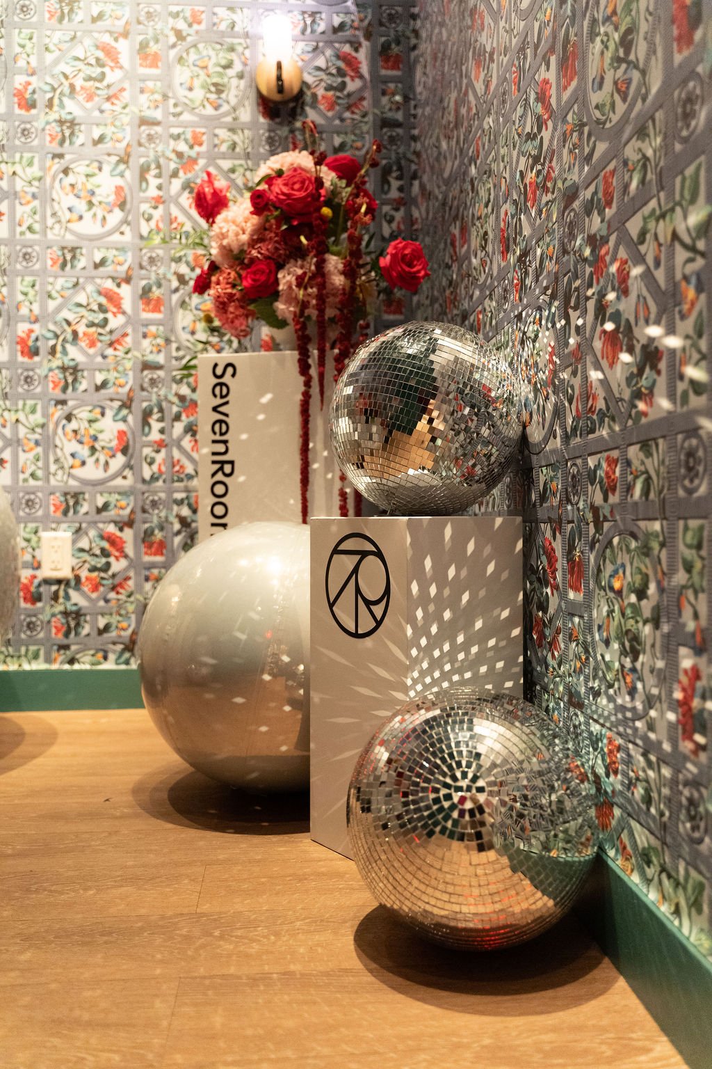Custom event décor with disco balls and florals designed for the SevenRooms graduation party