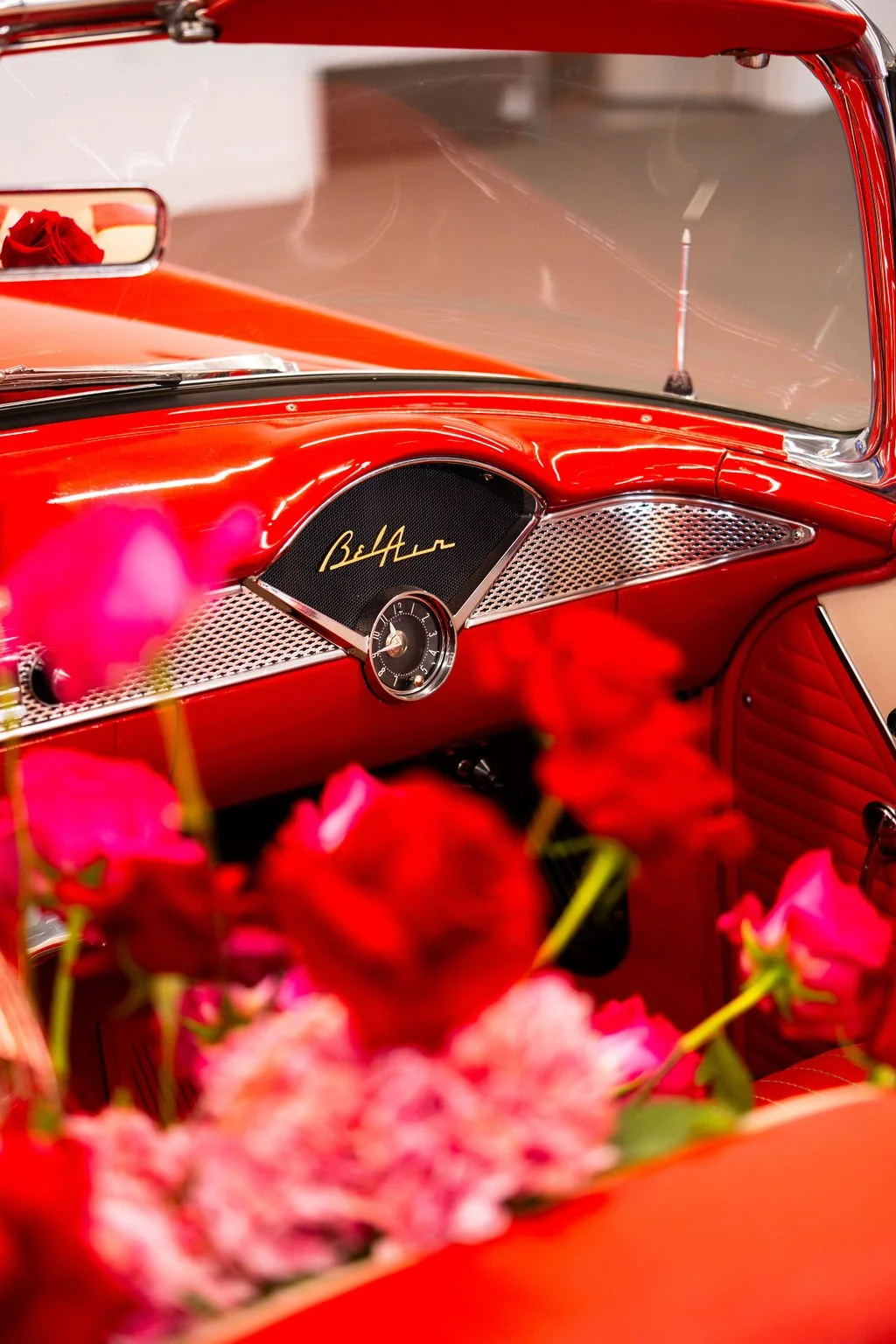 Classic red car interior styled with roses for a Valentine’s Day event at Motor Enclave in Tampa, Florida.