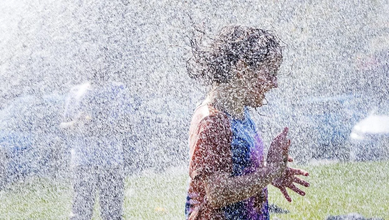 Lily-Ann Ward, 7, has fun under the Milson Volunteer Fire Brigade’s hose.Warwick Smith / Manawatū Standard