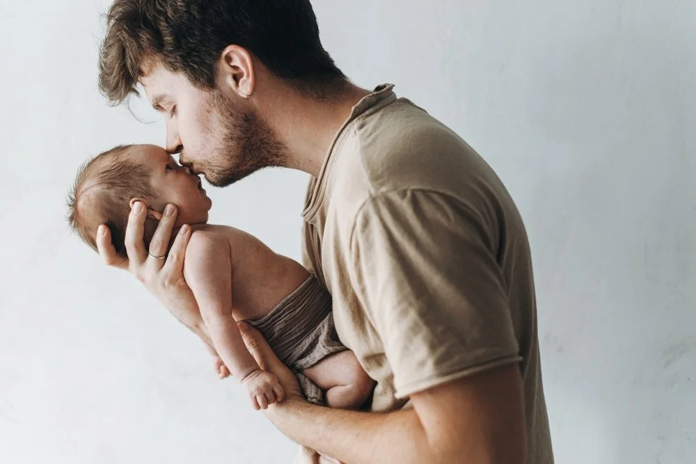 A father holding and kissing his newborn baby on the nose |  SACCounty Health Beginnings