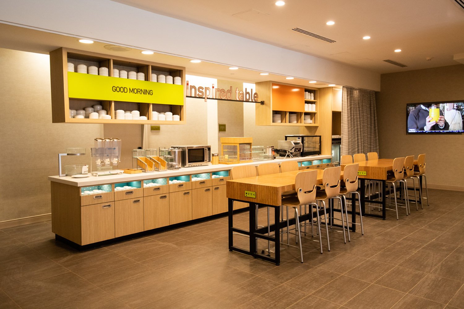 Home2 Suites by Hilton and Tru by Hilton breakfast bar featuring custom millwork, storage, and counters