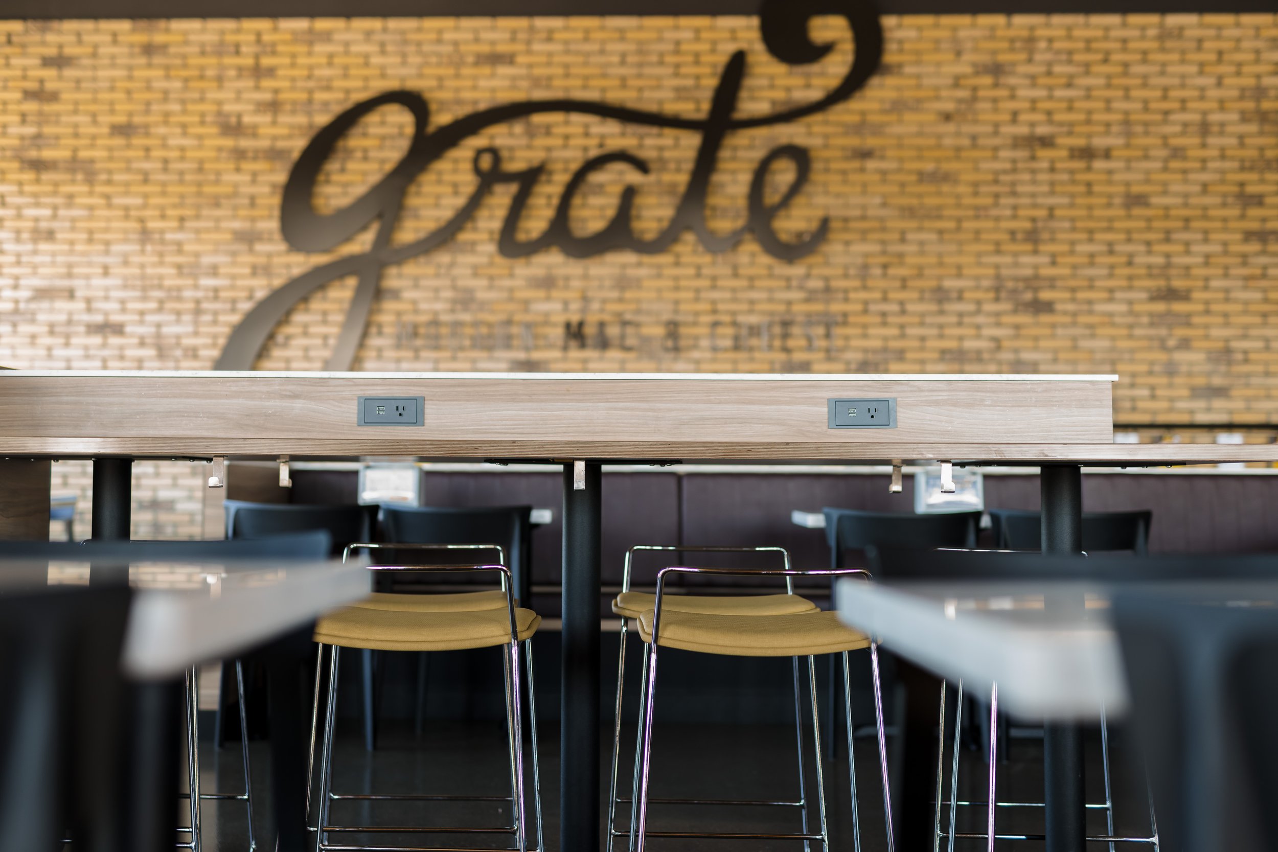 dining room features high top tables with charging stations