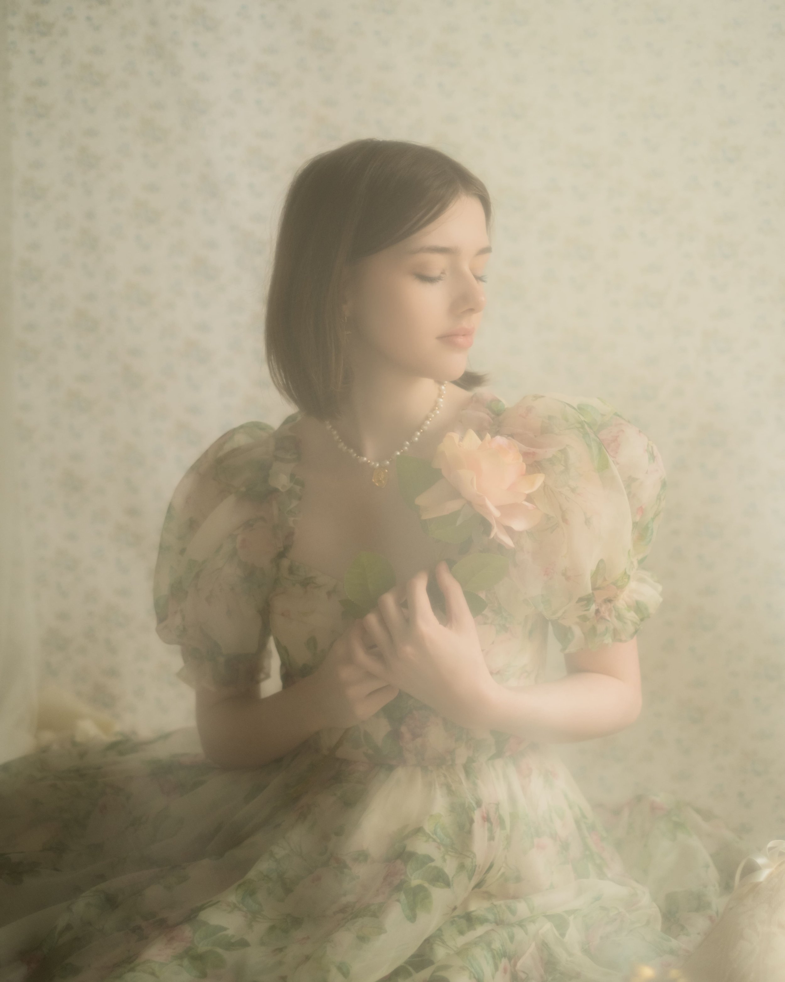 A woman in a vintage floral dress holding pink peonies with a soft, dreamy filter.
