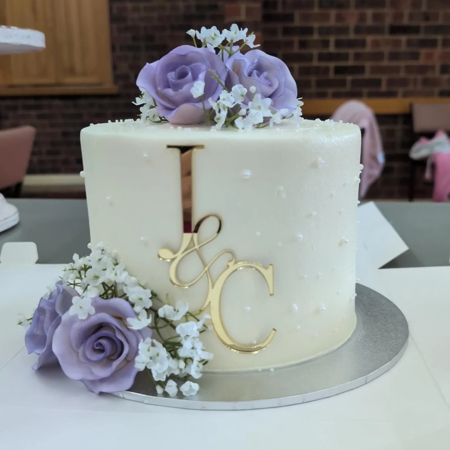 We created a Quadruple layer cake for a Wedding 💜🤍💍

The gorgeous sugar pearls, flowers and cake toppers were all added by the customer 😊 
Look how beautiful it turned out!

All of our products are 100% vegan, gluten &amp; nut free 

Need a cake 