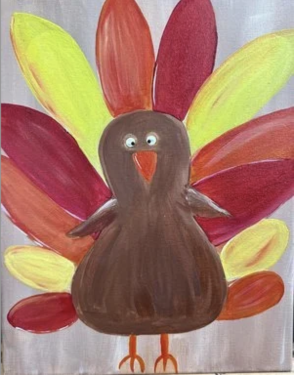 Colorful craft of a turkey with a brown body, orange beak and feet, big white eyes, and vibrant feathers in red, orange, yellow, and green.