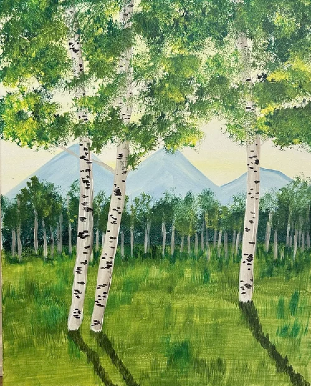 Watercolor painting of a forest scene with tall white birch trees in the foreground, green grass, distant trees, and mountains in the background under a pale sky.