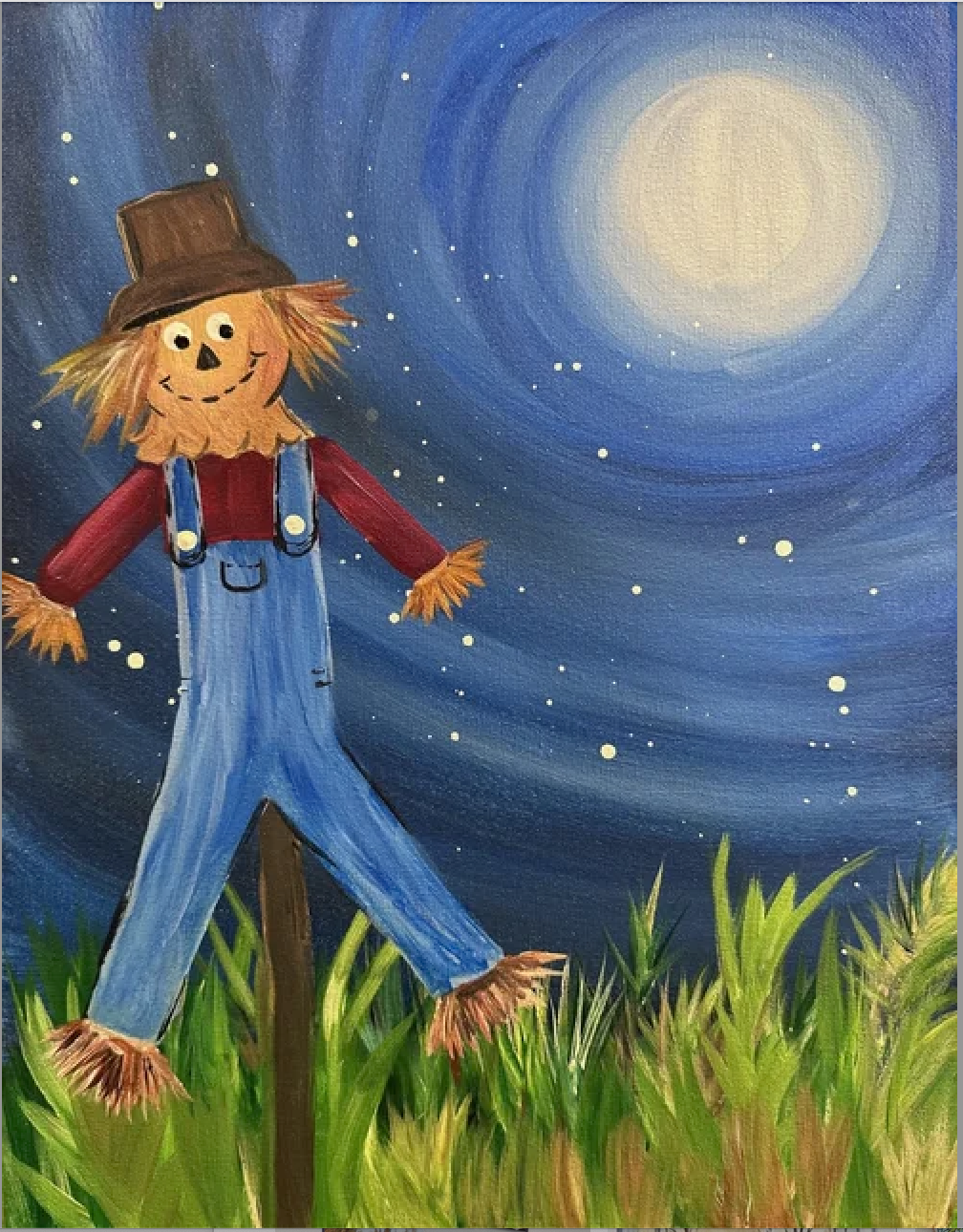 A cheerful scarecrow with a pumpkin face, wearing a brown hat, red shirt, blue overalls, and straw hair and feet, standing in a field of green grass under a starry night sky with a bright full moon.