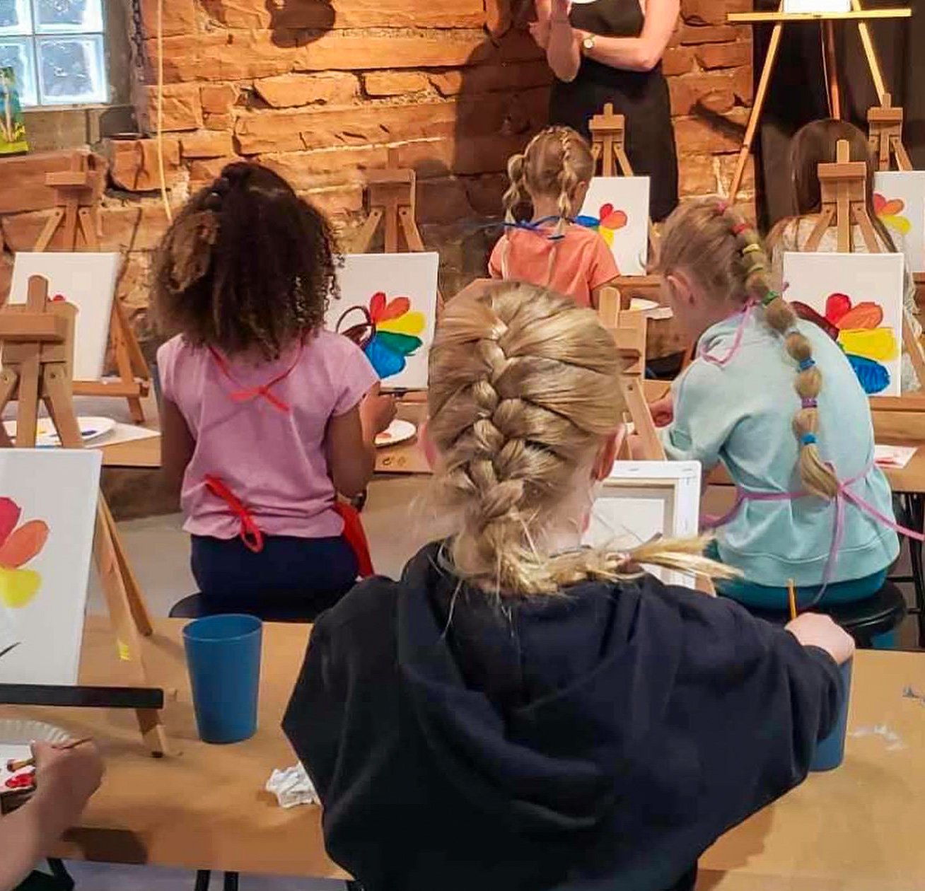 Children participating in a kids painting class at Inspiration Haven Art Studio in Heber City, Utah.