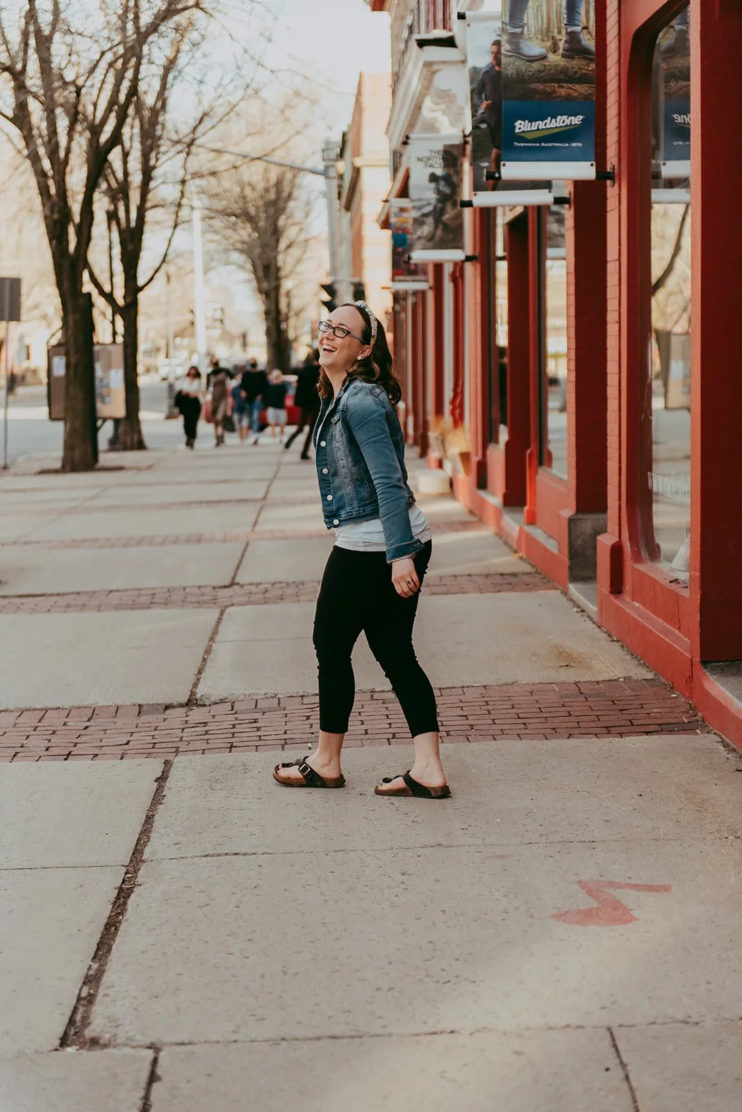 Jenn laughs as she walks down the sidewalk in Fredericton