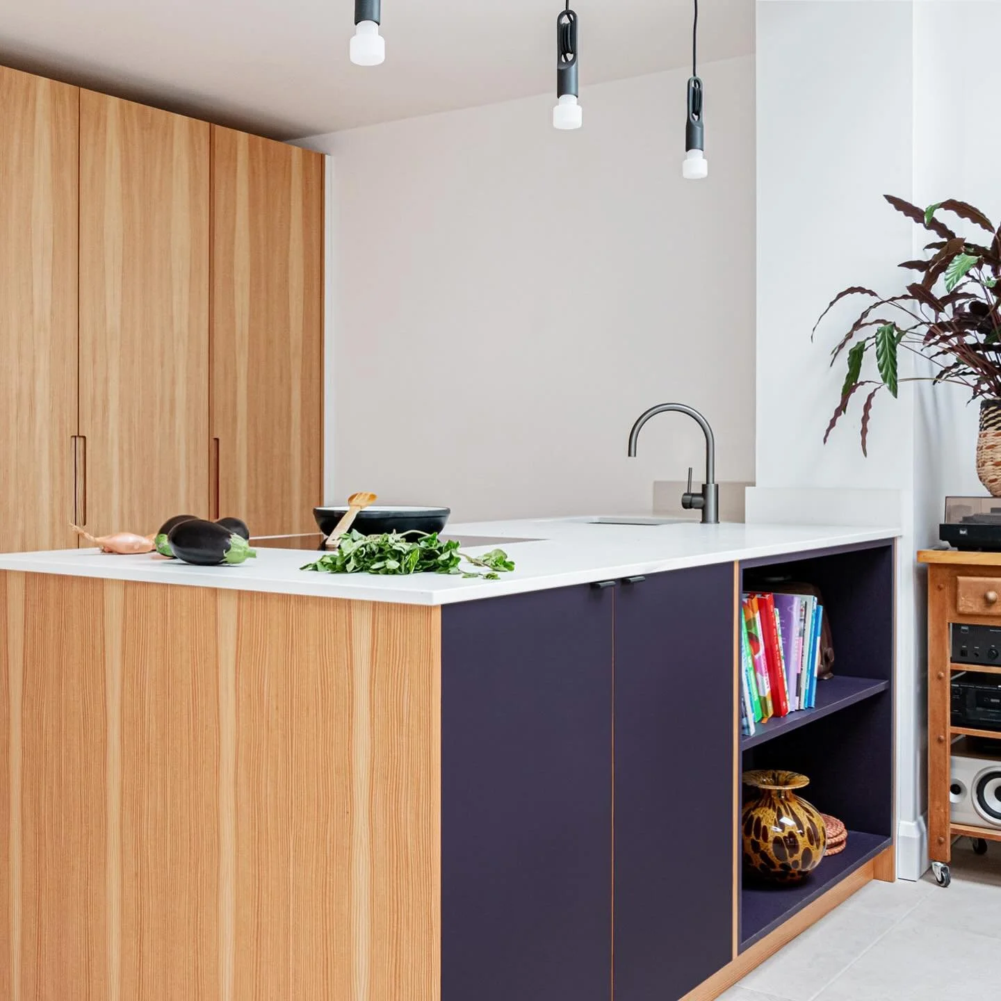 Larch and Fenix peninsular kitchen in Lewes. Larch veneers from the fantastic @capitalcrispinveneer were hand stitched and pressed in-house, and sit alongside Rosso Namib and Viola Orissa Fenix.