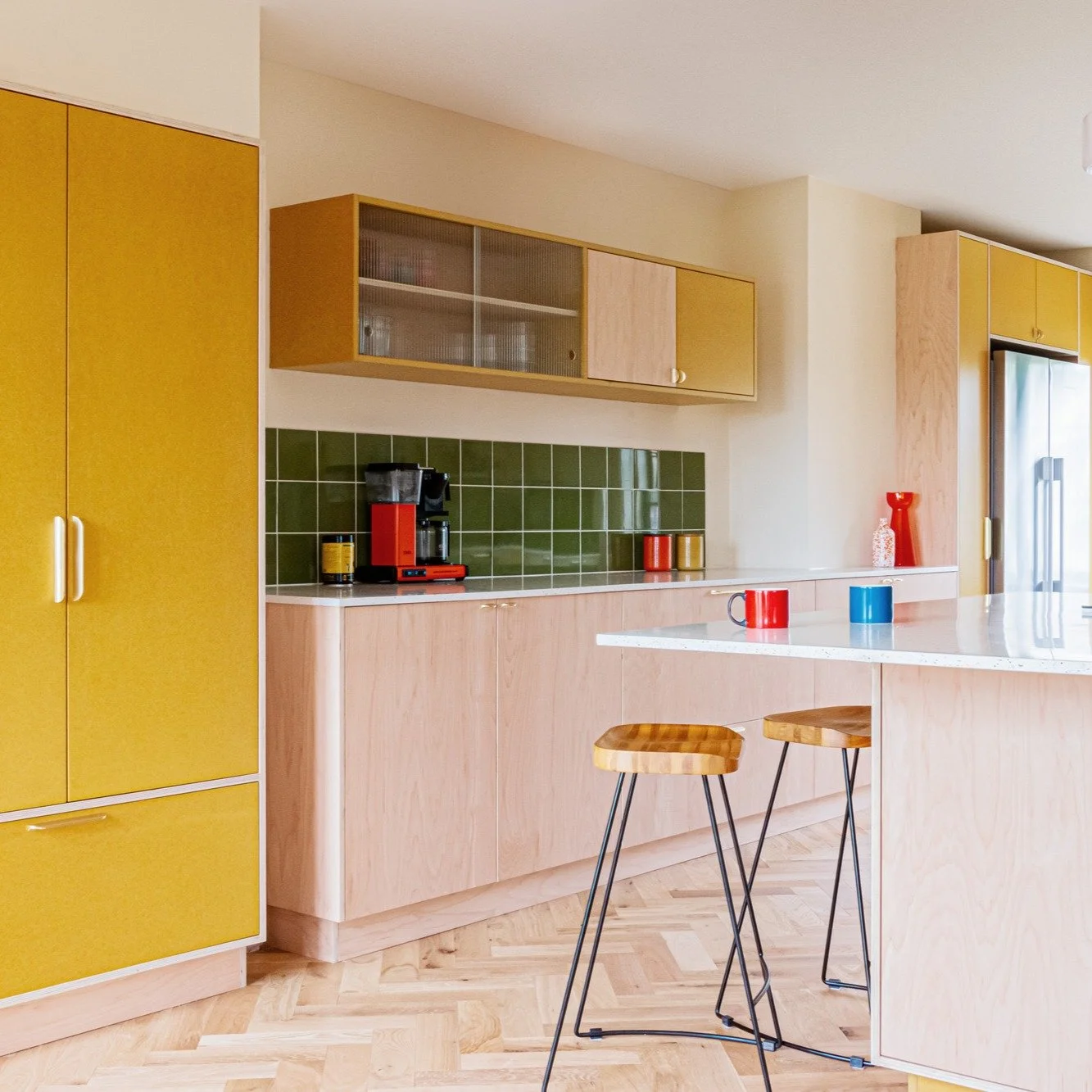 A playful balance of modern materials; turmeric yellow Valchromat, Garnica maple plywood, and recycled plastic worktops by Polygood.