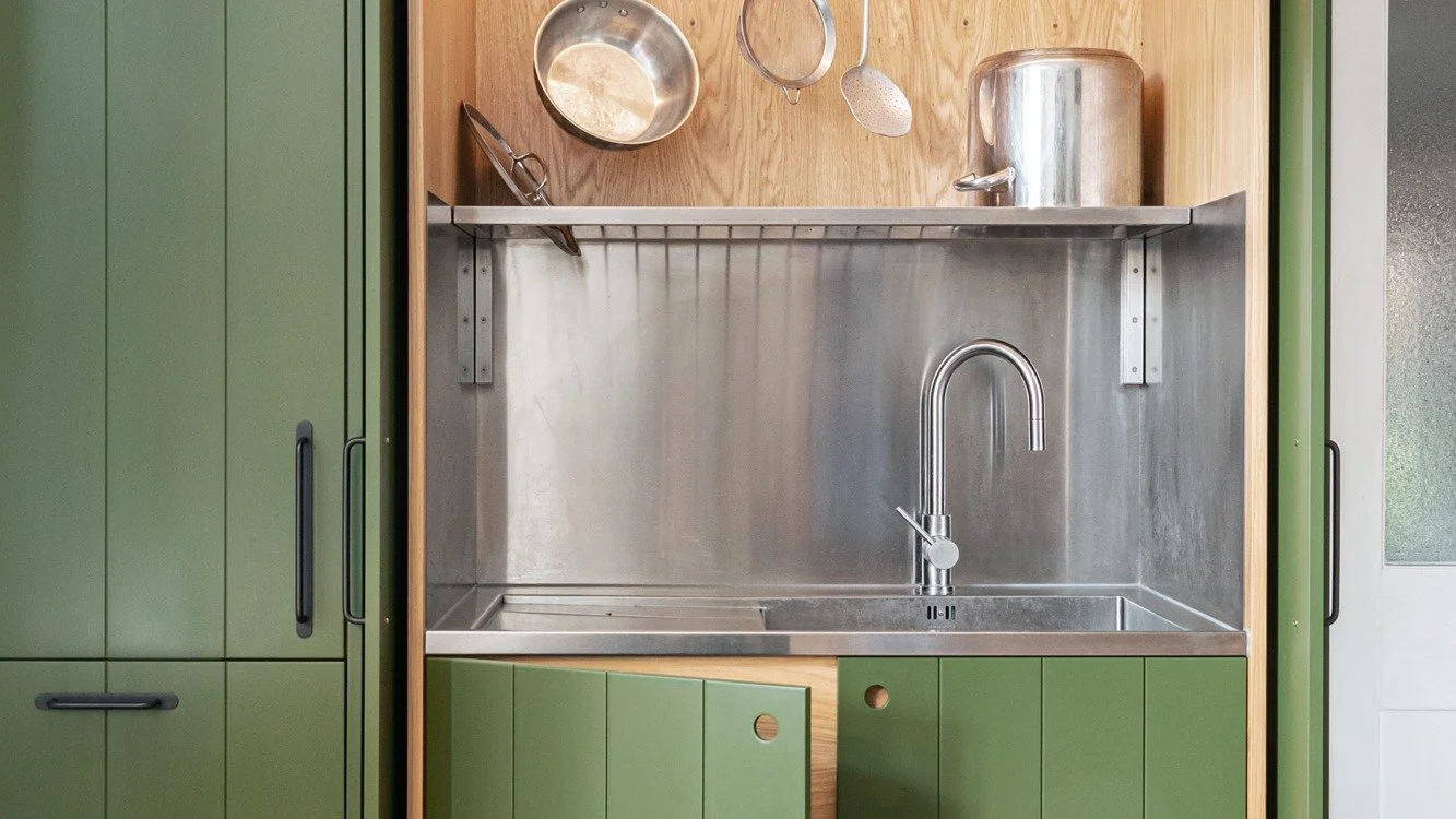 One of the joys of having a bespoke kitchen made - if you want your sink to be behind closed doors, you can have it! There's lots of other secret storage hidden away there too...