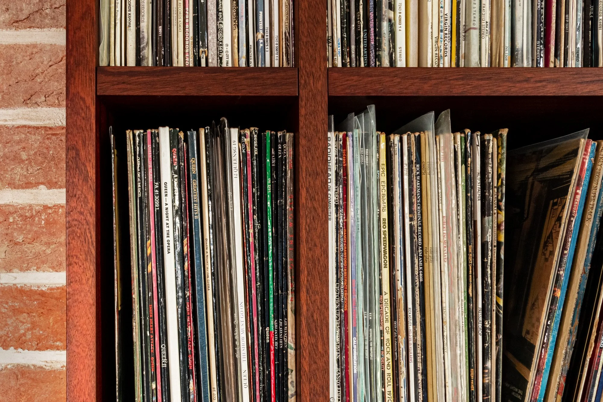 A close up of lots of vinyl records displayed in bespoke shelving