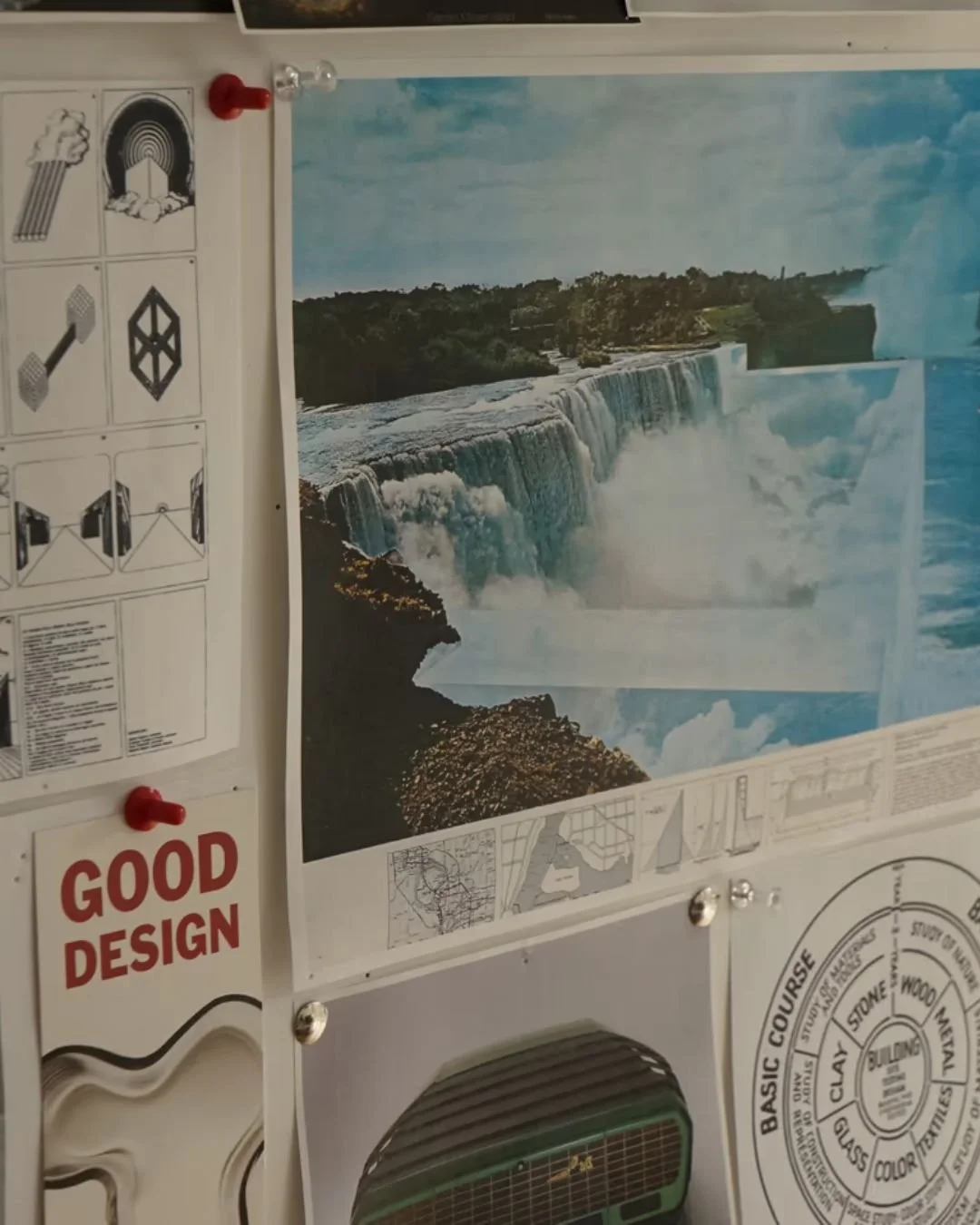 Photograph of a bulletin board with various images, including a large poster of Niagara Falls, a diagram titled 'Good Design,' and other informational diagrams and text.