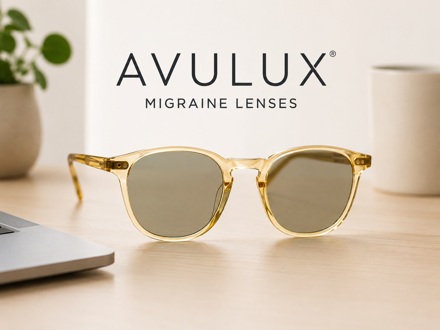 Avulux migraine lenses with selective light-filtering technology displayed in a modern neutral workspace setting.