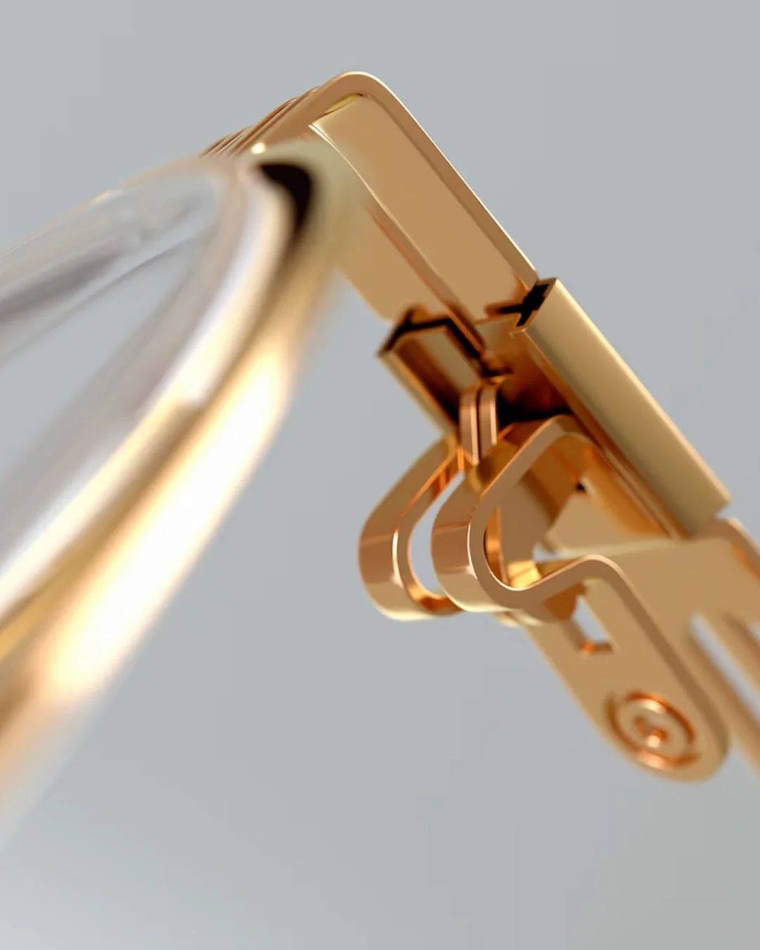 Close-up of a gold-colored hinge mechanism on lool eyewear connecting two parts of a device. - available in Edmonton at Helio Optometry
