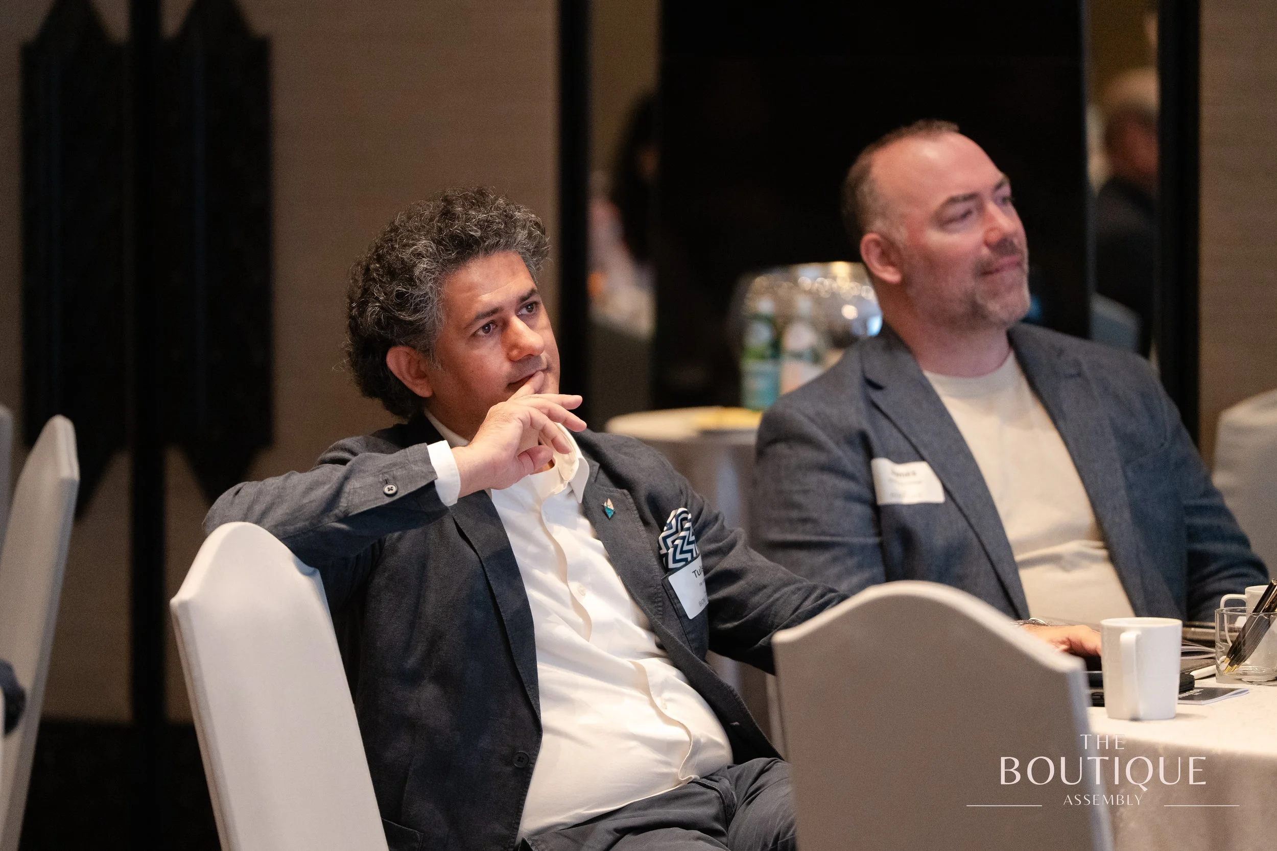Delegates listen and exchange reactions during the morning session at The Boutique Assembly.