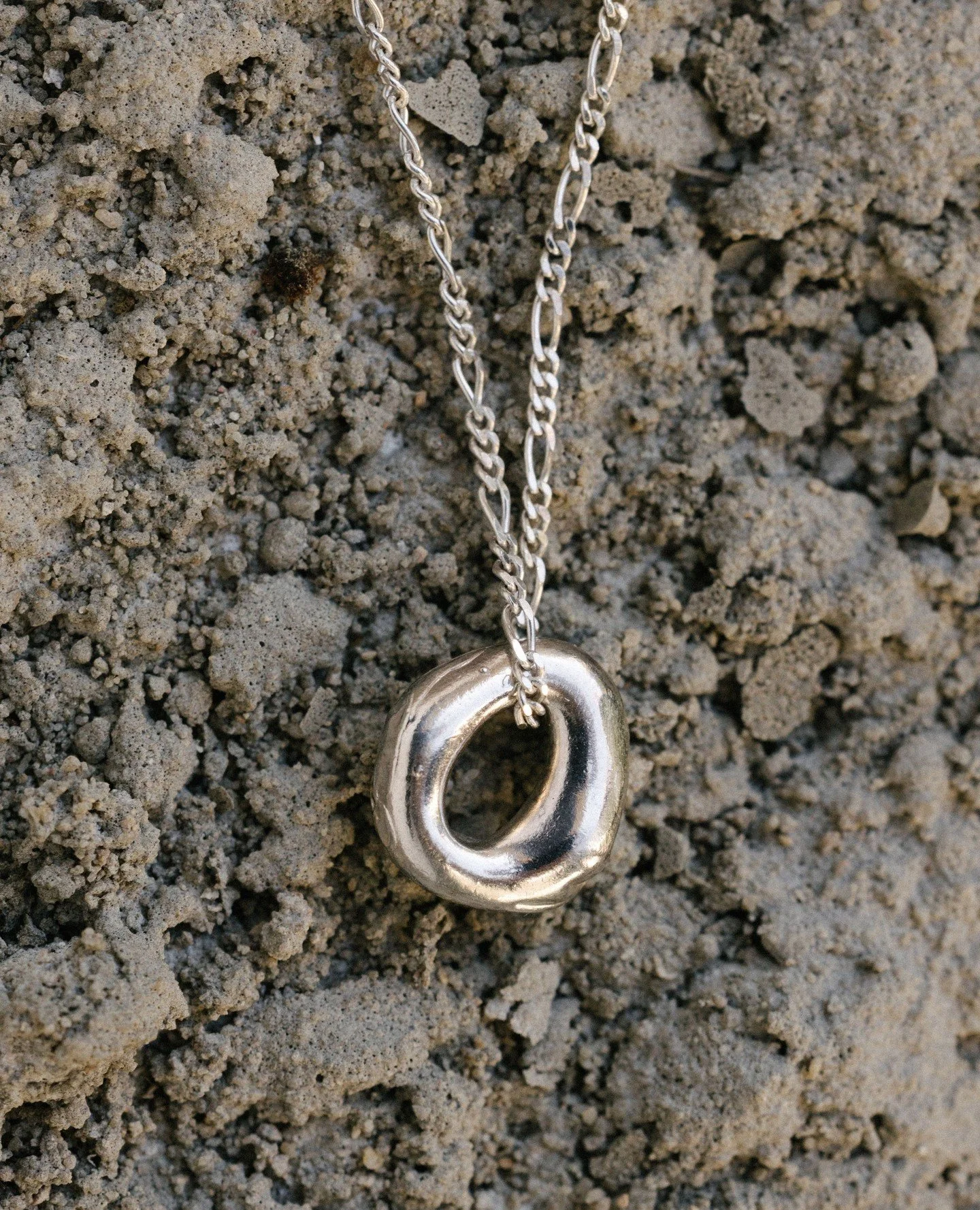 The Loop necklace, resting on the earth.