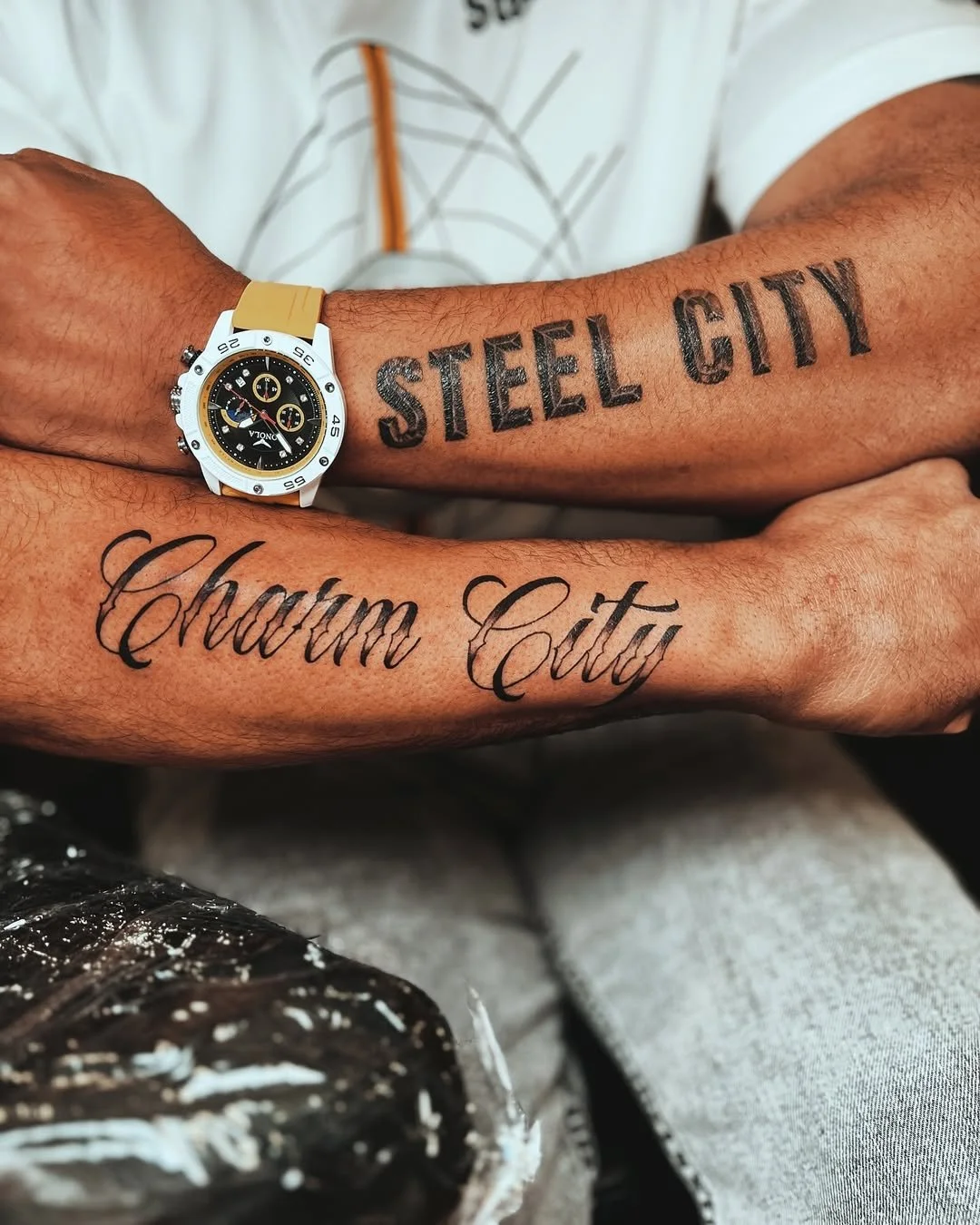"Steel City" / "Charm City" script
Bold blackletter and script lettering forearm pieces — Pittsburgh and Baltimore hometown tributes. By Stella Sanchez (@umbra.inks), now booking at Dark Water Tattoo Studio in Berkeley.