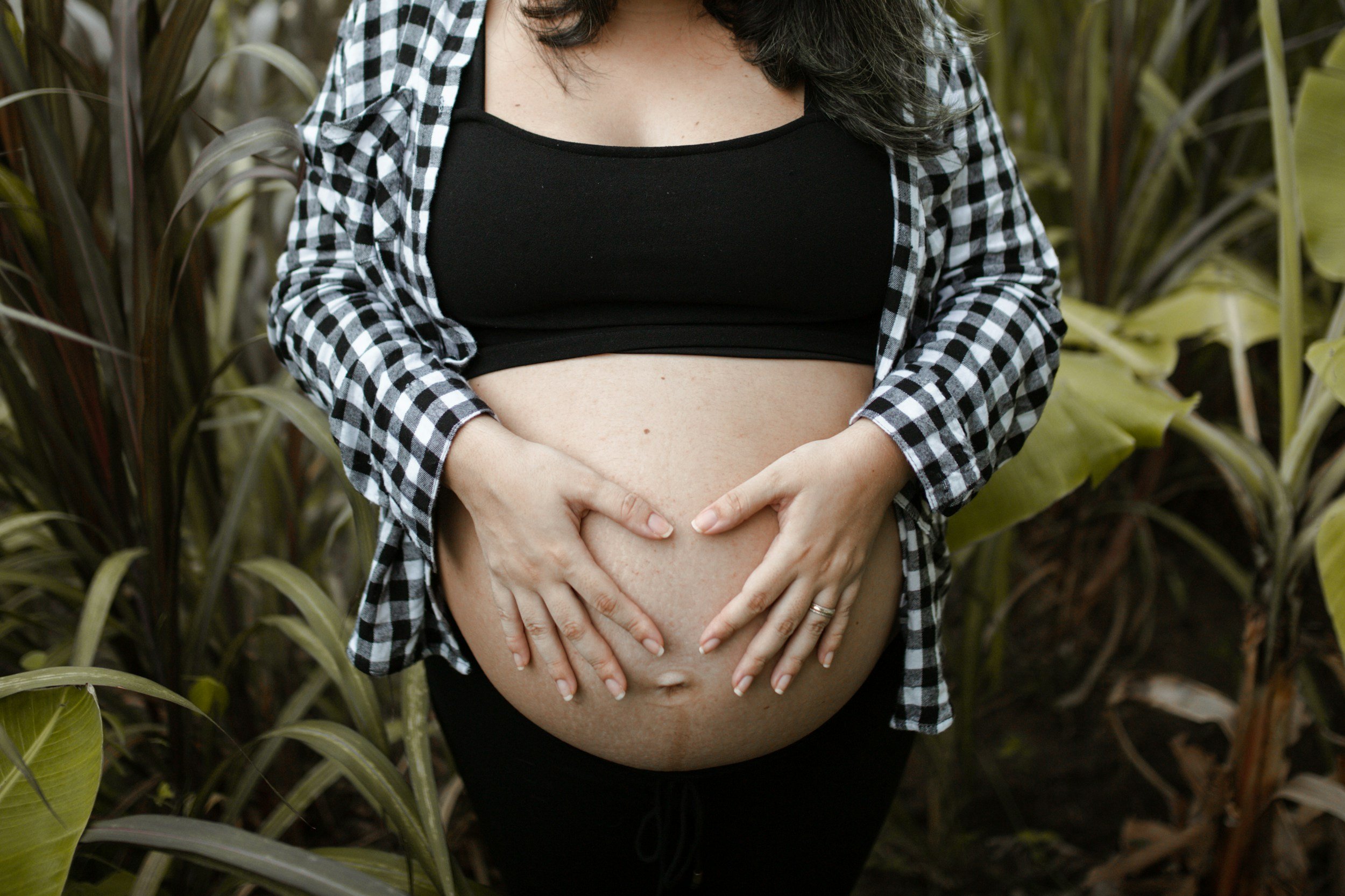 Pregnant woman holding her baby bump representing mental health support, self care, and emotional wellness during pregnancy in Birmingham, Alabama.